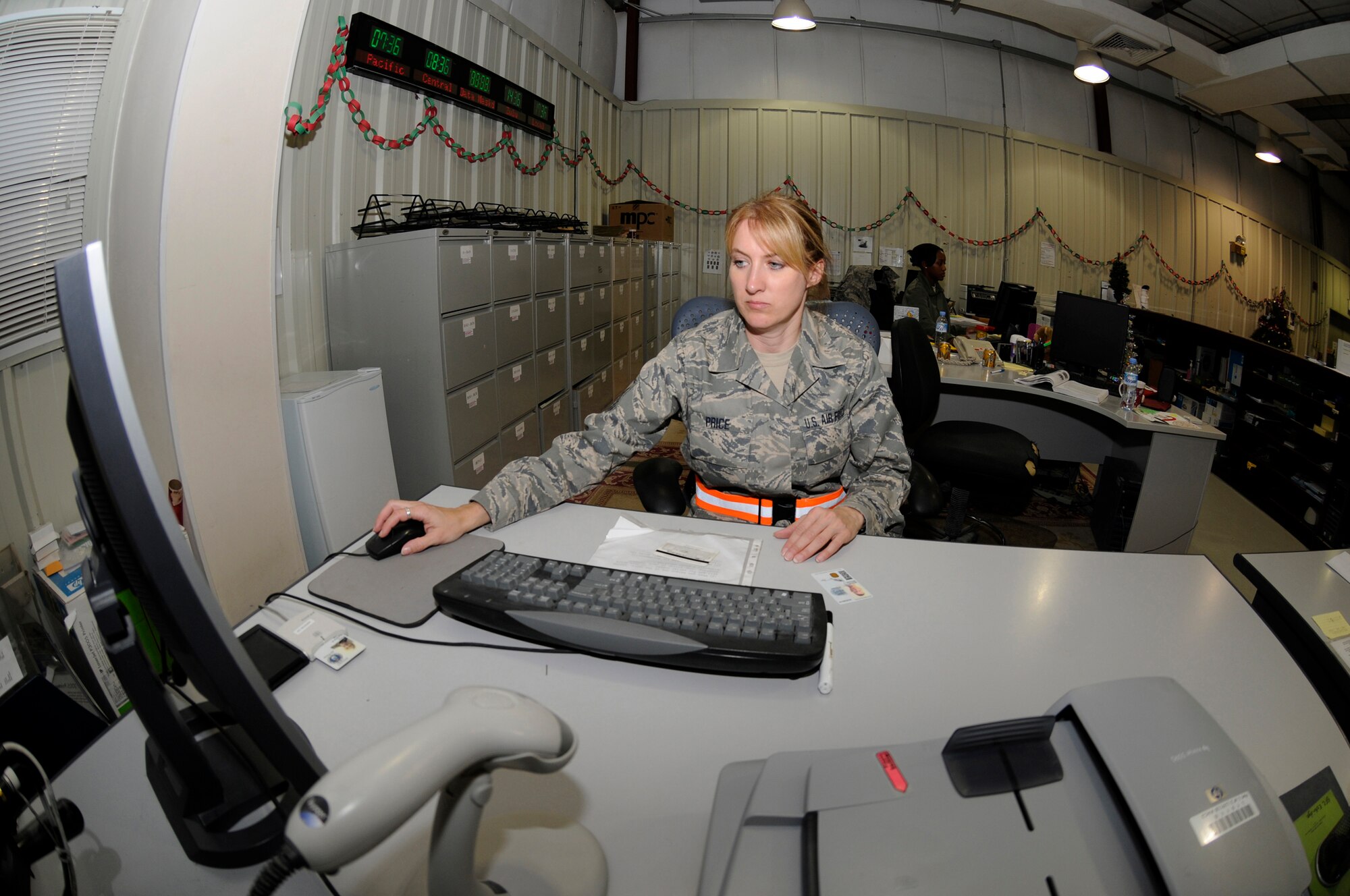 Master Sgt. Cyndi Price, a personnelist assigned to the 379th Expeditionary Force Support Squadron, finalizes information on a new identification card she generated, Dec. 25, at an undisclosed air base in Southwest Asia. The personnel support for contingency operations team generates almost 200 ID cards a month as cards are lost, worn, expired or required for promotion.  Sergeant Price, a native of Derby, Kan., is deployed from McConnell Air Force Base, Kan., in support of Operations Iraqi and Enduring Freedom and Joint Task Force-Horn of Africa. (U.S. Air Force photo by Tech. Sgt. Michael Boquette/Released)