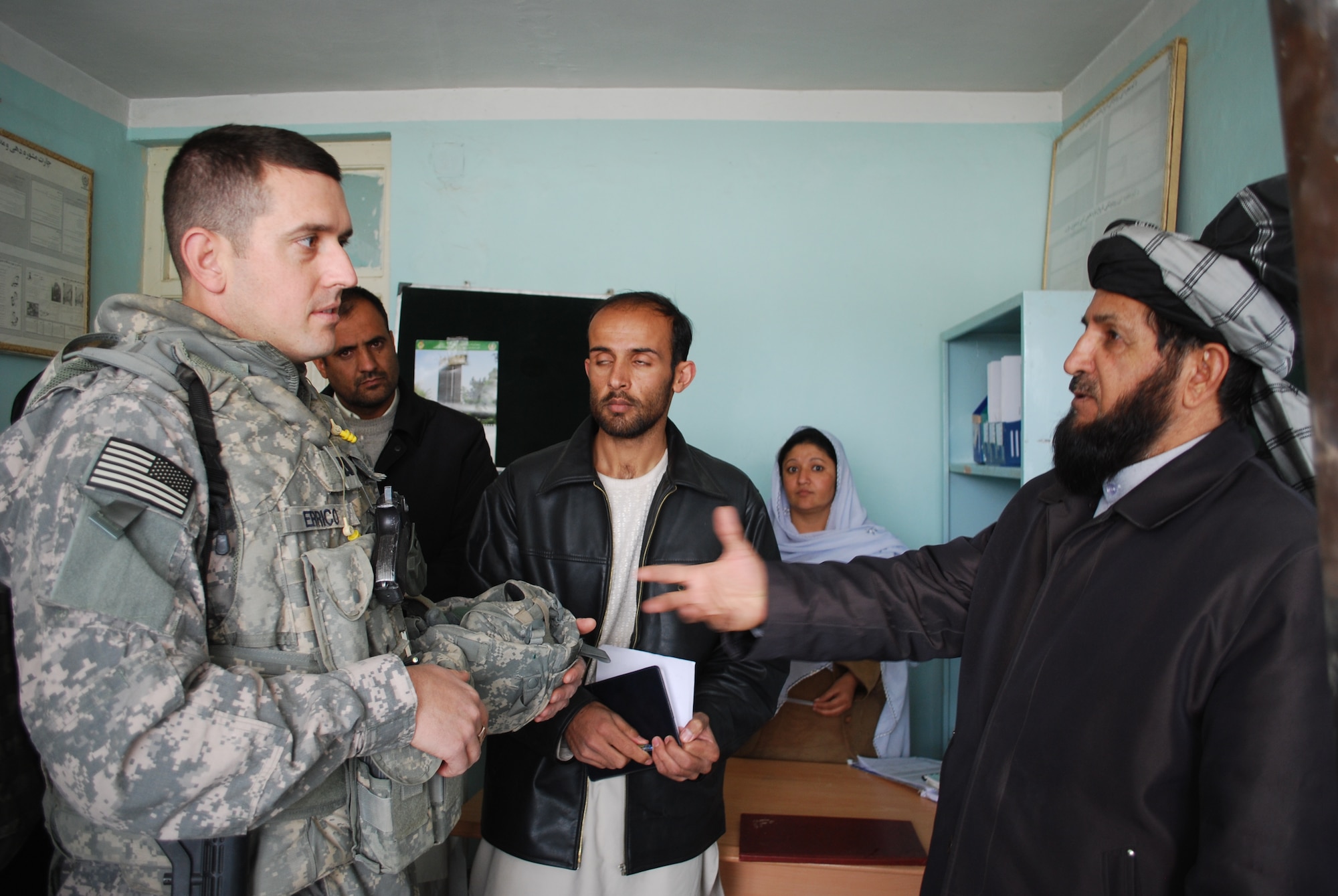 Air Force Dr. (Capt.) William Ericco listens to Governor Del Bar Arman talk about the medical facilities currently in Shajoy. Dr. Ericco is a physician with the Zabul Provincial Reconstruction Team.