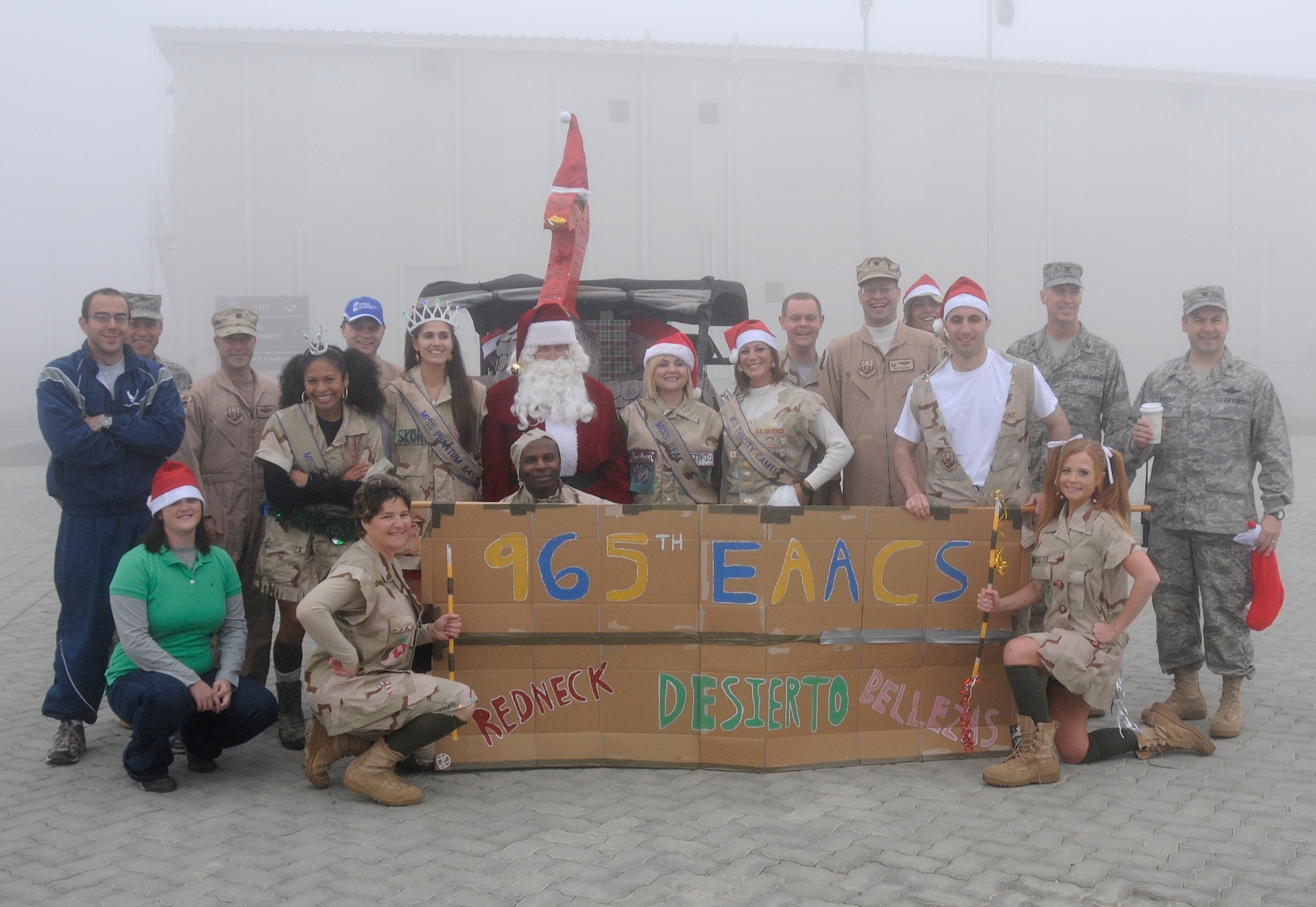 SOUTHWEST ASIA -- Members of the 380th Air Expeditionary Wing pose for a group photo at the end of the Holiday Parade here Dec. 25. The 380th celebrated the holidays with a variety of events Dec. 21 through 25 to bring some holiday cheer to a deployed environment.  (U.S. Air Force photo/Tech. Sgt. Christopher A. Campbell) (released)
