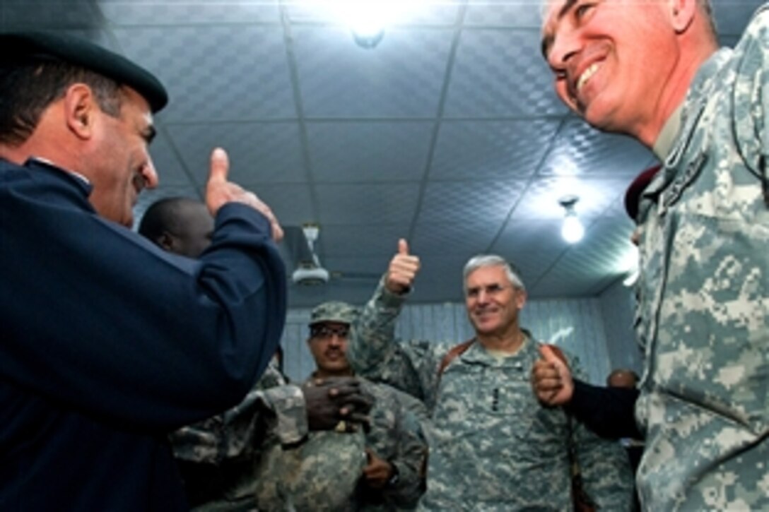 Gen. George Casey, Army chief of staff, gives a thumbs up to the Iraqi police, Iraqi Army and U.S. Army troops who work together in the Maysan province's equivalent to a 9-1-1 call center in Amarah, Iraq, Dec. 21, 2008. Casey met with provincial police and military leaders, and he spent time with the troops of the 2nd Battalion, 7th Cavalry  Regiment, 4th Brigade Combat Team, 1st Cavalry  Division stationed at Forward Operating Base Garry Owen. 