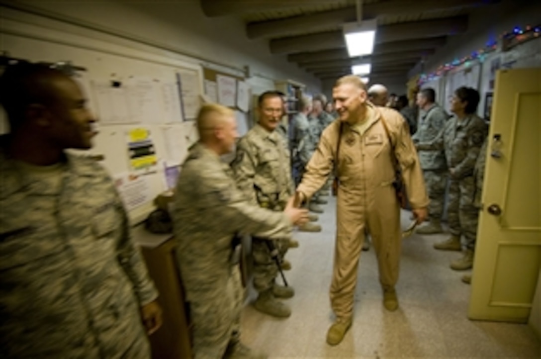 Lt. Gen. Gary North, U.S. Air Forces Central commander, shakes hands with airmen of the 755th Expeditionary Civil Engineer Squadron at Bagram Air Field, Afghanistan, Christmas Eve, Dec. 24, 2008. North relayed ambitious plans for further construction at Bagram Air Field. 