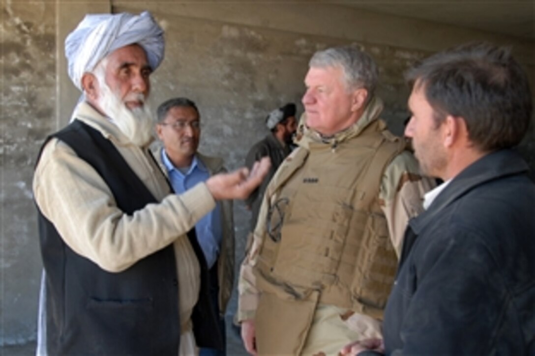 Deputy Governor of Khost Province Taiwar Khan Subarai, left, and Chief of Naval Operations Gary Roughead discuss the construction of the Provincial Government Center, Dec. 22, 2008, as Provincial Reconstruction Team Khost's Afghan Cultural Advisor Aiaz Khan translates the conversation. Roughead and Master Chief Petty Officer of the Navy Rick West toured the facility as part of their visit to PRT Khost. 