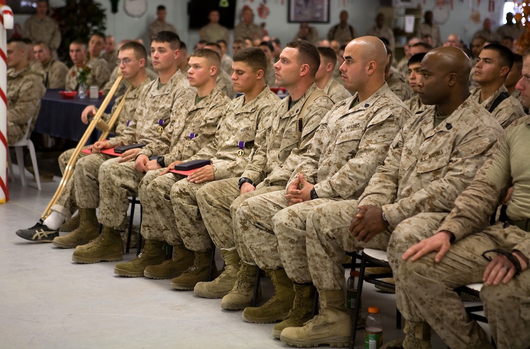 Marines from Company C, Task Force 1st Battalion, 3rd Marine Regiment, Regimental Combat Team 1, listen after Marines from 2nd Platoon were presented with a Purple Heart for injuries sustained in a recent Improvised Explosive Device attack, by the Commandant of the Marine Corps, General James Conway. The Commandant and Sergeant Major of the Marine Corps visited with Marines Friday at the Camp Baharia Dining Facility to thank them for all their hard work and sacrifices. (Official U.S. Marine Corps Photo / Released)