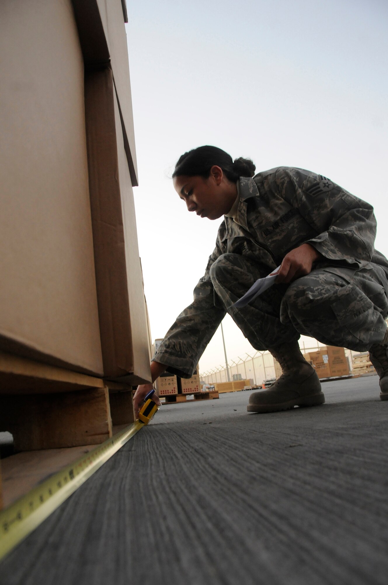 Senior Airman Jennifer Oropeza-Magee, 379th Expeditionary Logistics Readiness Squadron Distribution Flight, measures the size of some priority cargo Dec. 26, 2008, at an undisclosed air base in Southwest Asia. These ELRS members are responsible for forwarding cargo received here to the area of responsibility in support of the Global War on Terrorism. Airman Oropeza-Magee, a native of Los Angeles, Calif., is deployed from Aviano Air Base, Italy, in support of Operations Iraqi and Enduring Freedom and Joint Task Force-Horn of Africa. (U.S. Air Force photo by Staff Sgt. Darnell T. Cannady/Released)