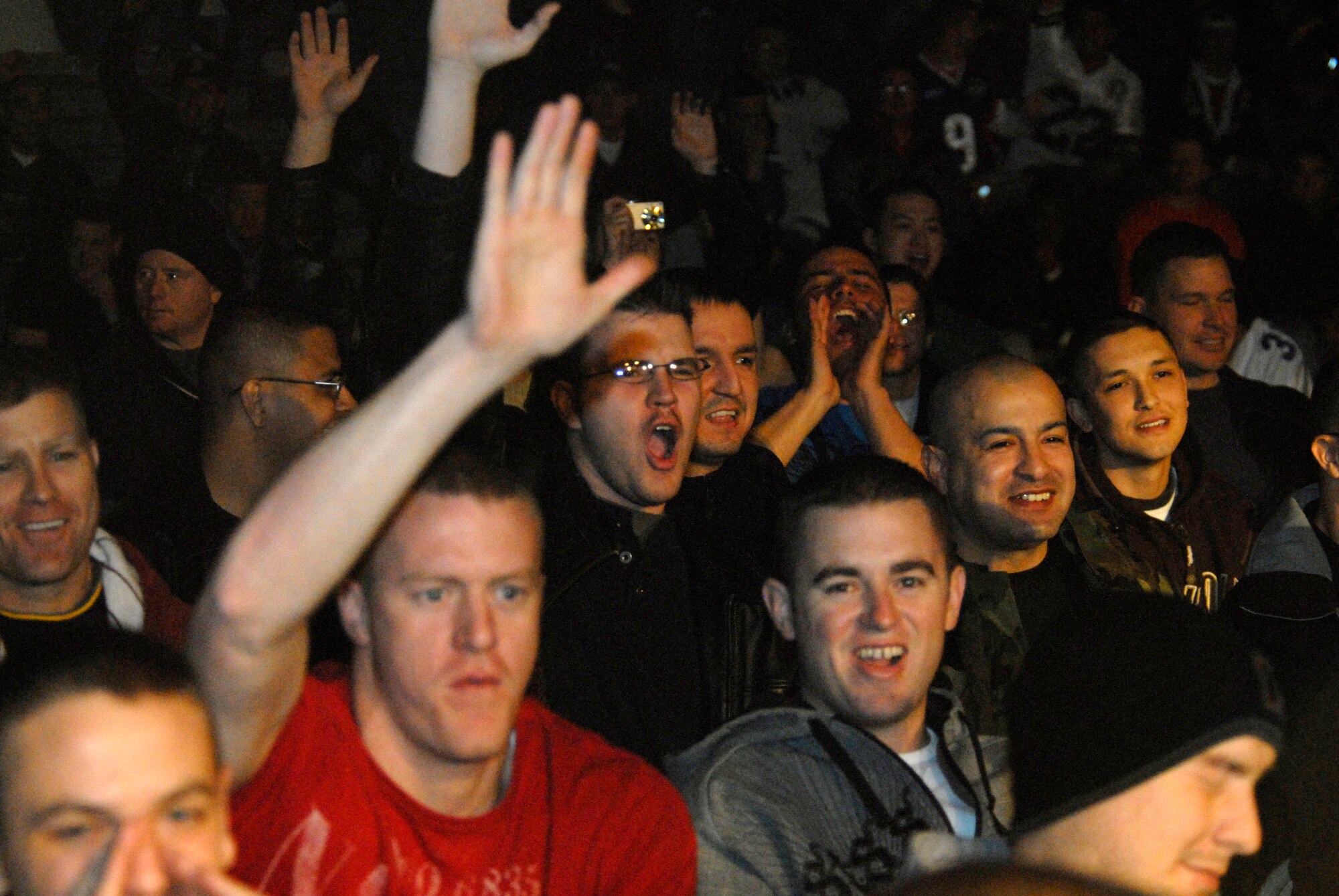 Members of the Wolf Pack cheer and volunteer to be called upon to answer a trivia question by Trisha Trevino of the Dallas Cowboys Cheerleaders during the United Services Organization show, Dec. 26, 2008, Kunsan Air Base, Republic of Korea. (U.S. Air Force Photo by Staff Sgt. Jason Colbert)