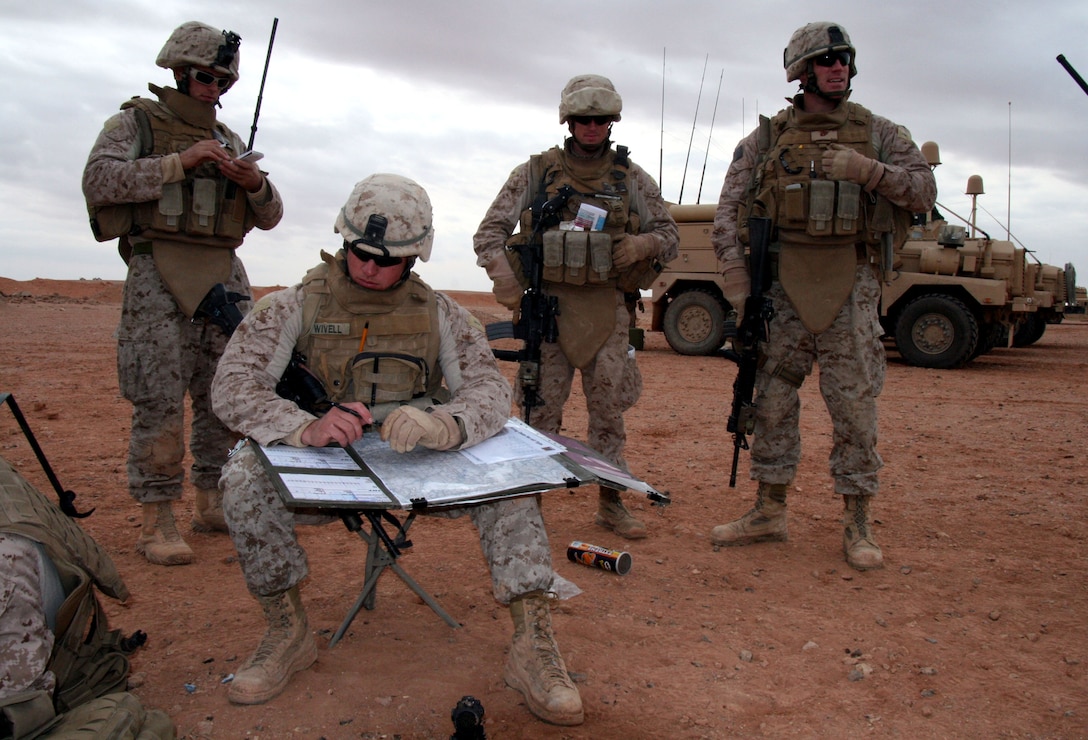 Second Lt. Adam Wivell, a Reserve Marine platoon commander with Echo Company, 2nd Battalion, 25th Marine Regiment, Regimental Combat Team 5, computes a timeline to integrate and deconflict 81mm mortars and close air support during a tactical air control party live-fire exercise in western al-Anbar desert, Iraq, Dec. 27, 2008.