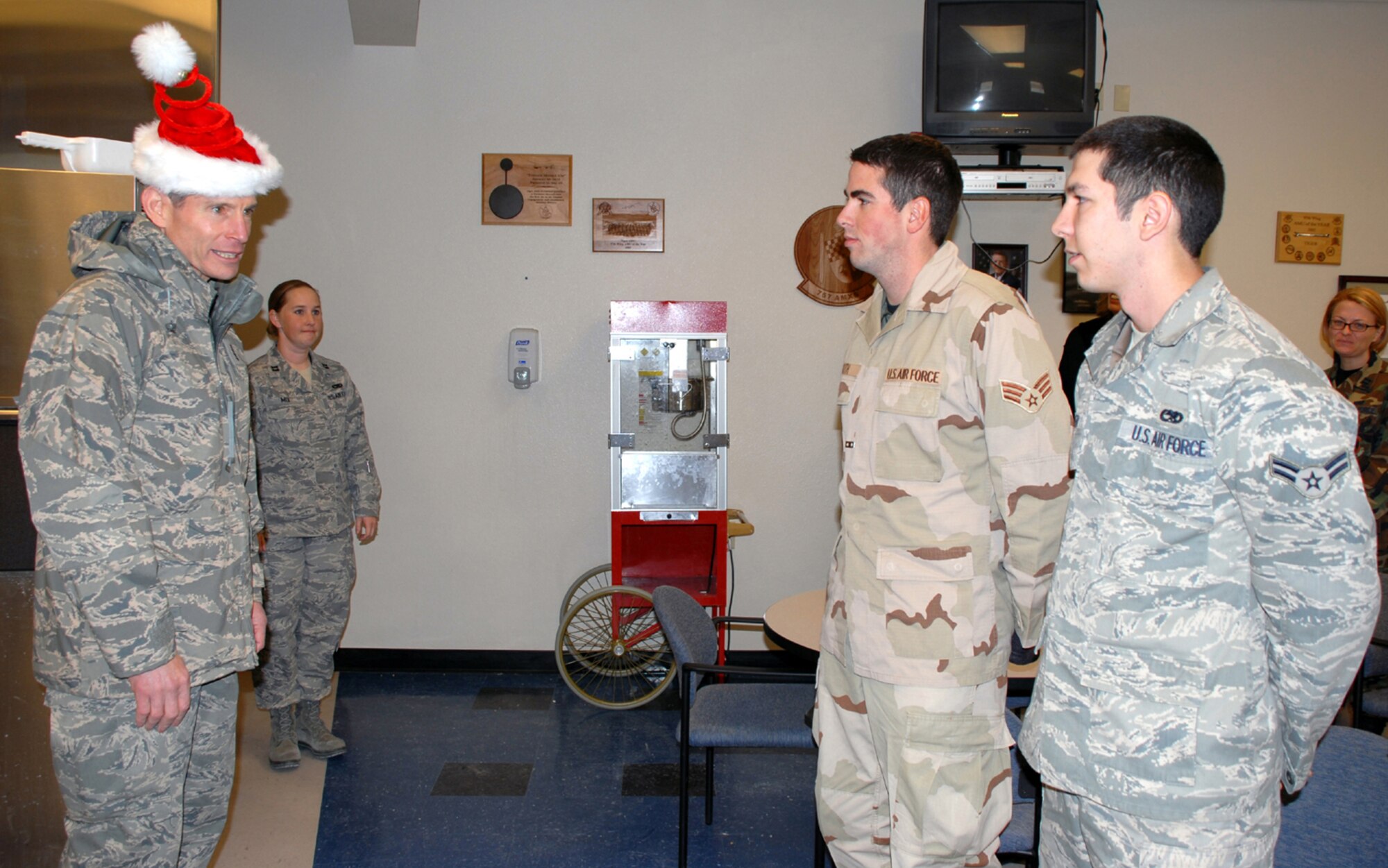 Gen. Norton Schwartz, Air Force chief of staff, speaks with Senior Airman James Koth and Airman 1st Class Trevor Vera, assigned to the 432d Aircraft Maintenance Squadron at Creech Air Force Base, Nev., during a Christmas day visit. General Schwartz and his wife Suzie visited Creech to thank Airmen for their support to the war on terrorism. (U.S. Air Force photo/Staff Sgt. Alice Moore) 