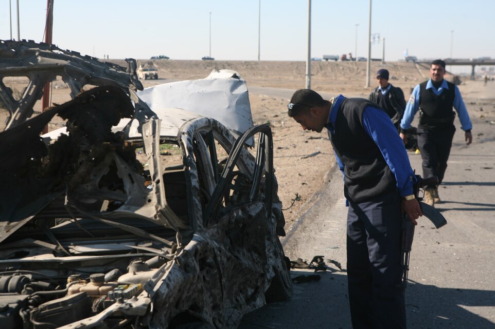 Iraqi police with the Karmah police station investigate a suicide attack and search for suspects on a local highway in Fallujah, Iraq, Dec. 28. Iraqi Security Forces were quick to respond to the situation and provided casualty assistance to injured personnel.