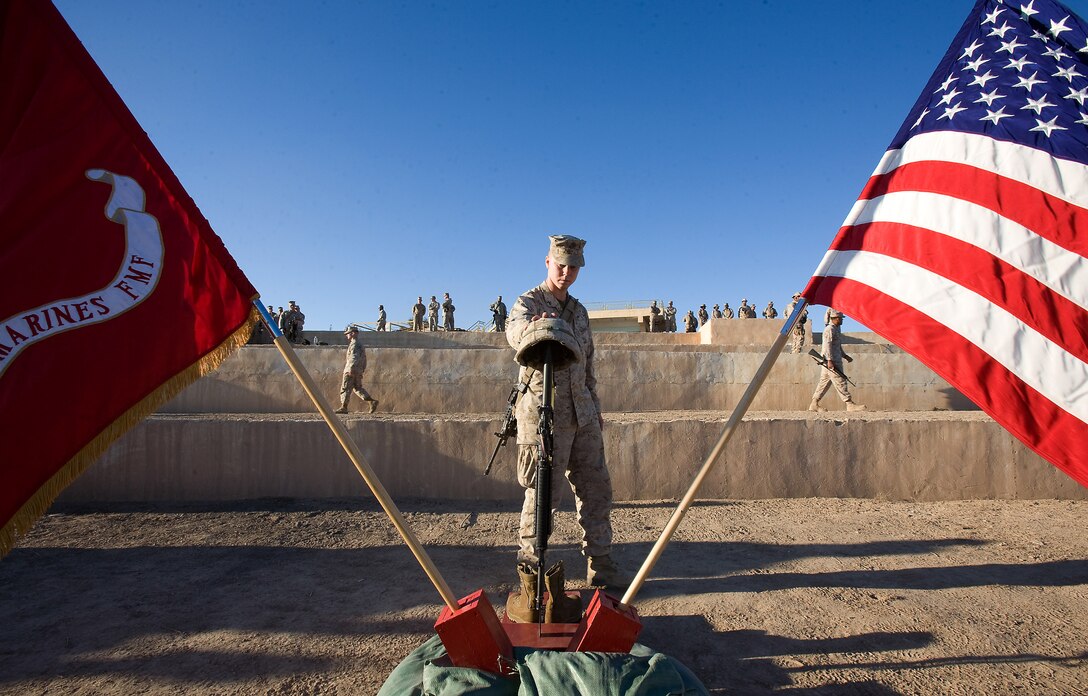 Lance Cpl. Robert Eckmann, with C Company, Task Force 1st Battalion, 3rd Marine Regiment, Regimental Combat Team 1, pays his respects to Lance Cpl. Thomas J. Reilly Jr., a 19-year-old rifleman from London, Ky., with the company’s 2nd Platoon. Marines honored Reilly during a memorial ceremony, Dec. 28. Reilly was killed in action during a patrol in Karmah, Iraq, Dec. 21.