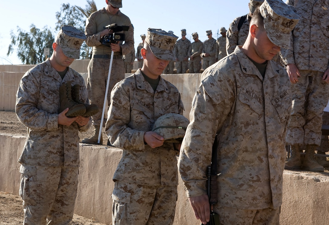 Marines with C Company, Task Force 1st Battalion, 3rd Marine Regiment, Regimental Combat Team 1, prepare to place a rifle, helmet, and boots in honor of Lance Cpl. Thomas J. Reilly, Jr., a 19-year-old rifleman from London, Ky., who was with the company’s 2nd Platoon, during a memorial ceremony Dec. 28. Reilly was killed in action during a patrol in Karmah, Iraq, Dec. 21.