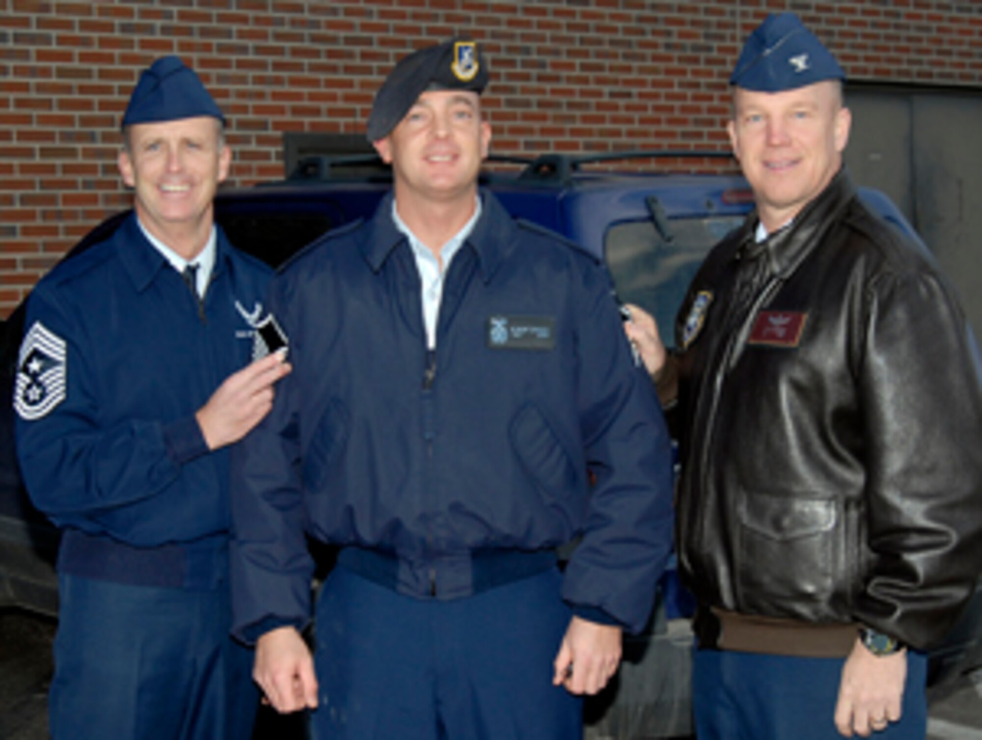 Newly-promoted Master Sgt. Robert J. Cawley stands with Col. Jay Raymond, 21st Space Wing commander, and Chief Master Sgt. Timothy Omdal, 21st Space Wing command chief, after being ‘STEP’ promoted Dec. 22. Known as ‘Stripes for Exceptional Performers,’ units use additional promotion slots to promote exceptional members in their organizations. Sergeant Cawley is assigned to the 21st Security Forces Squadron. (U.S. Air Force photo/Roberta McDonald) 
