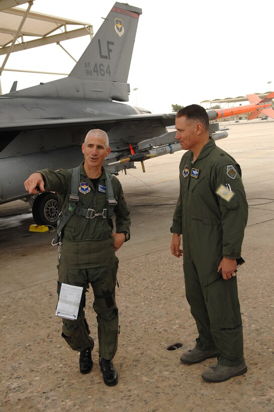 Col. David Lujan (left), 56th Operations Group deputy commander, shares a laugh with Brig. Gen. Kurt Neubauer, 56th Fighter Wing commander at Luke Air Force Base, Ariz., Dec. 22, moments after he completed his 4,000th hour in the F-16 Fighting Falcon. He is the 17th pilot to reach this milestone.  (U.S. Air Force photo/Tech Sgt. Jeffrey A. Wolfe)