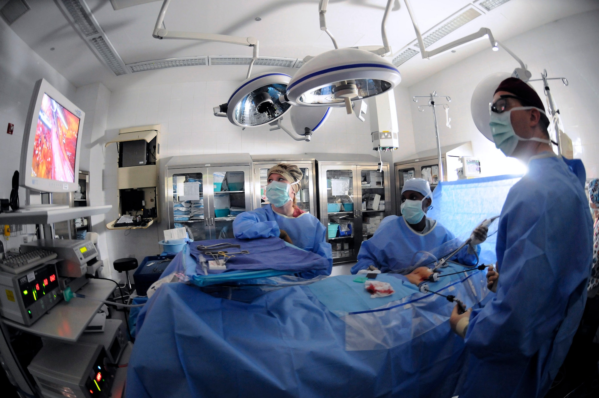 Senior Airman Cara Montgomery watches the monitor as Senior Airman Brittney Hardrick controls a camera so Dr. (Maj.) Craig Kolasch, general surgeon, can see inside a patient during a laparoscopic hernia repair. All Airmen are assigned to the 379th Expeditionary Medical Group. Airman Montgomery is a surgical technician.  Airman Hardrick is a cardio pulmonary technician. All are deployed from Keesler Air Force Base, Miss., in support of Operations Iraqi and Enduring Freedom and Joint Task Force-Horn of Africa. (U.S. Air Force photo/Staff Sgt. Darnell T. Cannady)