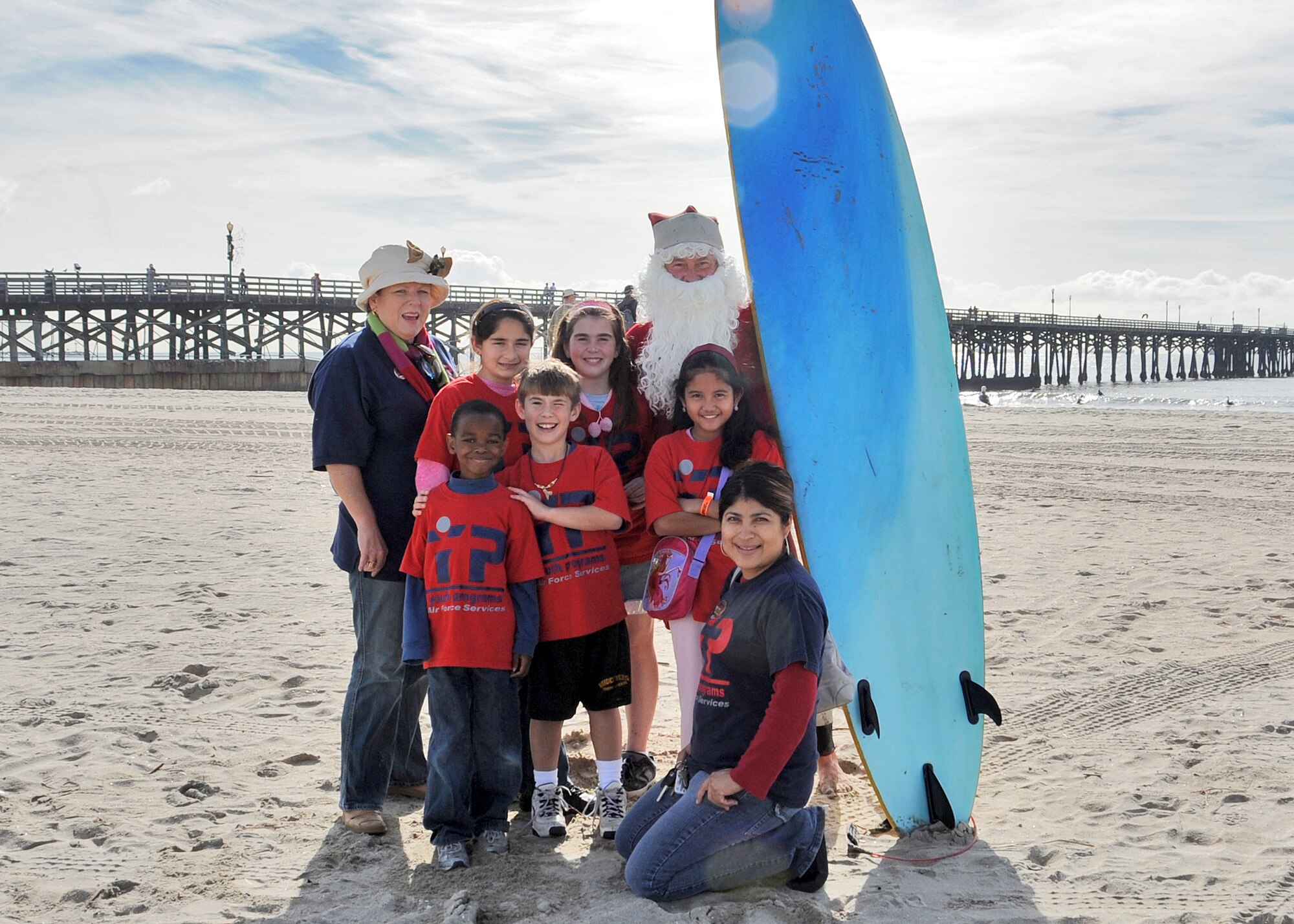 The children and their leaders from the Los Angeles Air Force Base Youth Services ran into a surfing Santa at Seal Beach, Calif., during their holiday shopping spree to buy gifts for friends and family, Dec. 23. The group visited a local shell store where they shopped for their gifts and enjoyed some treats at a local ice cream shop. (Photo by Joe Juarez)