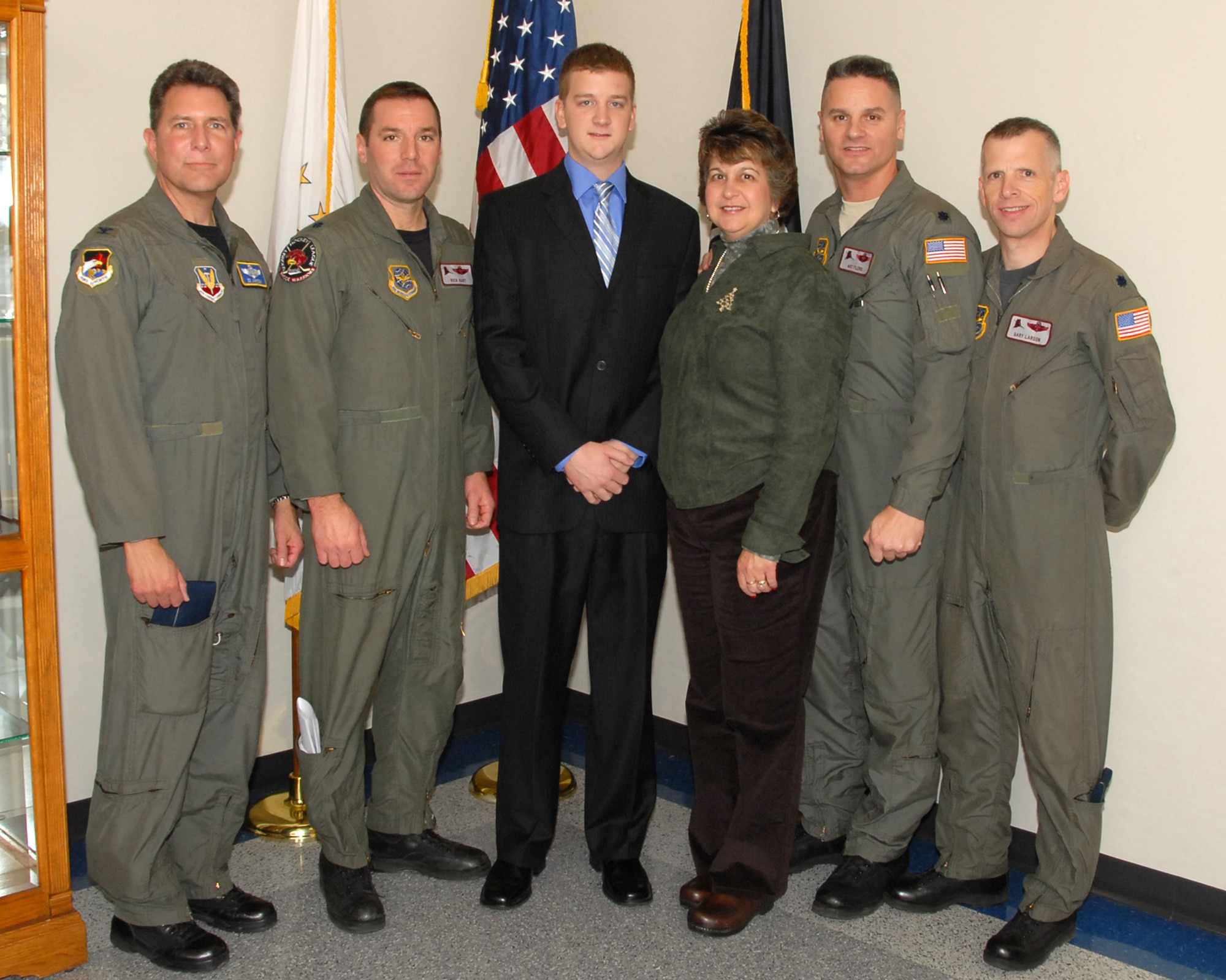 David Buckley, son of the late LtCol (ret) David Buckley, was sworn in as a UPT candidate here at Quonset ANGB, Saturday, 6 December 2008. David is following in his father's footsteps. LtCol Buckley, who flew with the 143d Airlift Wing for many years, passed away earlier this year. He would be very proud of his son's decision to join the 143d Operations Group. David is pictured with, from left to right, Col Ed Johnson, former C-130 Navigator, 143d Airlift Squadron (AS), LtCol Rick Hart, pilot, 143d AS, his mother Leslie Buckley, LtCol Arthur Floru, pilot, 143d Operations Support Flight Commander, and LtCol Gary Larson, pilot, 143d AS, all long time companions of David's father. We welcome him aboard. (USAF photo by Technical Sergeant Jason Long) (Released)