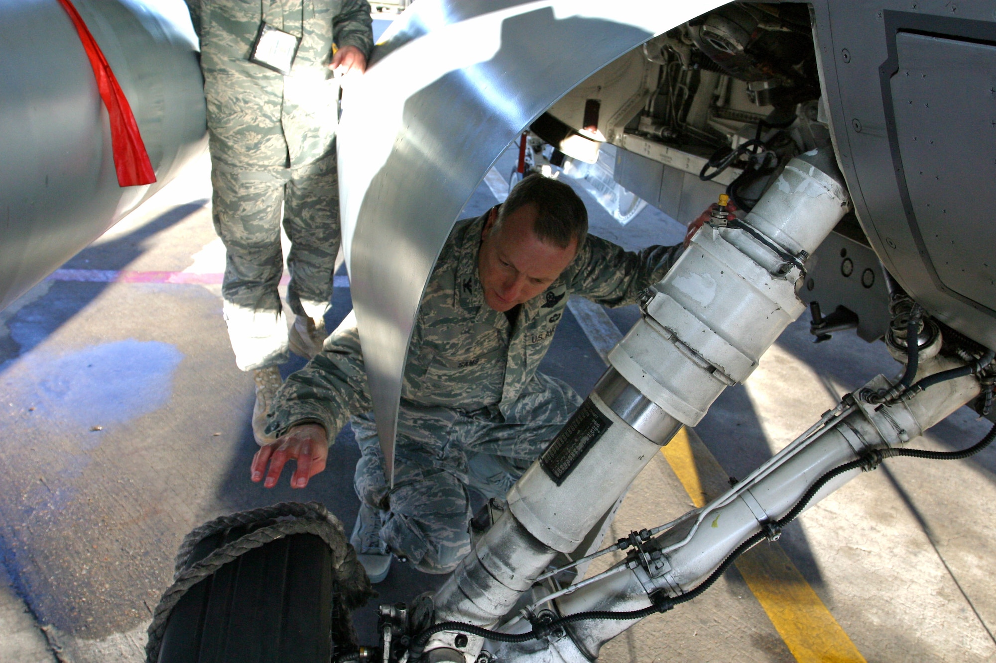 Col. Walter “Buck” Sams, 419th Fighter Wing commander, performs a preflight inspection on an F-16 Dec. 6. Colonel Sams was crew chief for a day during the December unit training assembly, which required hours of training the week prior to the launch. With assistance from Tech. Sgt. Wendy Baumgardner, 419th Aircraft Maintenance Squadron crew chief, Colonel Sams performed all the tasks that crew chiefs carry out to ensure aircraft take off and land safely –from meeting with the pilot beforehand to checking the cockpit for foreign objects afterward. “He seemed to really enjoy himself,” Sergeant Baumgardner said. “He was excited to be out there with us in the cold launching a jet.” (U.S. Air Force photo/Staff Sgt. Nathan Greer)