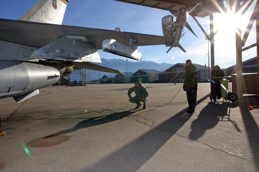 Col. Walter “Buck” Sams, 419th Fighter Wing commander, performs a preflight inspection on an F-16 Dec. 6. Colonel Sams was crew chief for a day during the December unit training assembly, which required hours of training the week prior to the launch. With assistance from Tech. Sgt. Wendy Baumgardner, 419th Aircraft Maintenance Squadron crew chief, Colonel Sams performed all the tasks that crew chiefs carry out to ensure aircraft take off and land safely –from meeting with the pilot beforehand to checking the cockpit for foreign objects afterward. “He seemed to really enjoy himself,” Sergeant Baumgardner said. “He was excited to be out there with us in the cold launching a jet.” (U.S. Air Force photo/Staff Sgt. Nathan Greer)