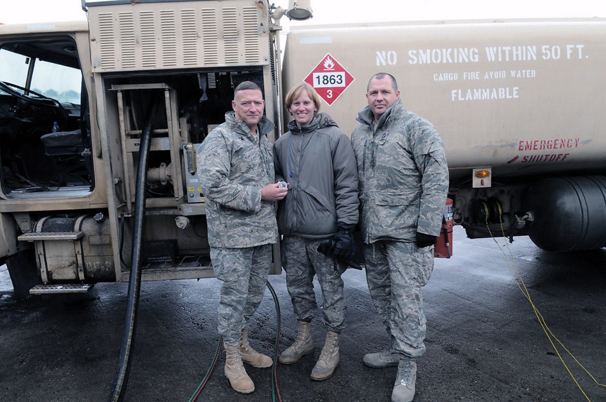 MANAS AIR BASE, KYRGYZSTAN -- Senior Airman Victoria Drefs, a fuels specialist with the 376th Air Expeditionary Wing here, recieves a commandr's coing from Lt. Gen Gary North, Air Forces Central Commander, for reaching the 2 million gallon mark for fuel delivered during her deployment.  The Armour S.D. native, deployed to Manas for four months from Aviano Air Base, Italy, is the first and likely only Airman to reach 2 million gallons this rotation. (Air Force photo / Senior Airman Ruth Holcomb)
