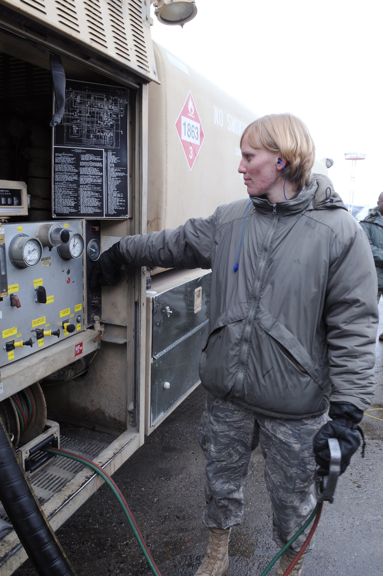 Senior Airman Victoria Drefs prepares to pump fuel from her R-11 fuel truck into a KC-135 Stratotanker to surpass the two million gallon mark for fuel delivered during her deployment. Airman Drefs is a fuels specialist with the 376th Air Expeditionary Wing at Manas Air Base, Kyrgyzstan. (U.S. Air Force photo/Senior Airman Ruth Holcomb)