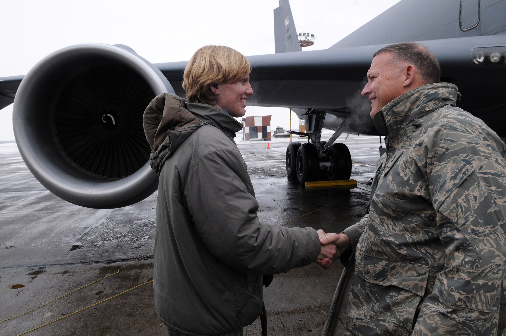 Senior Airman Victoria Drefs shakes hands with Lt. Gen. Gary North, U.S. Air Forces Central commander, as she is about to reach the two million gallon mark for fuel delivered during her deployment. Airman Drefs is a fuels specialist with the 376th Air Expeditionary Wing at Manas Air Base, Kyrgyzstan. (U.S. Air Force photo/Senior Airman Ruth Holcomb)