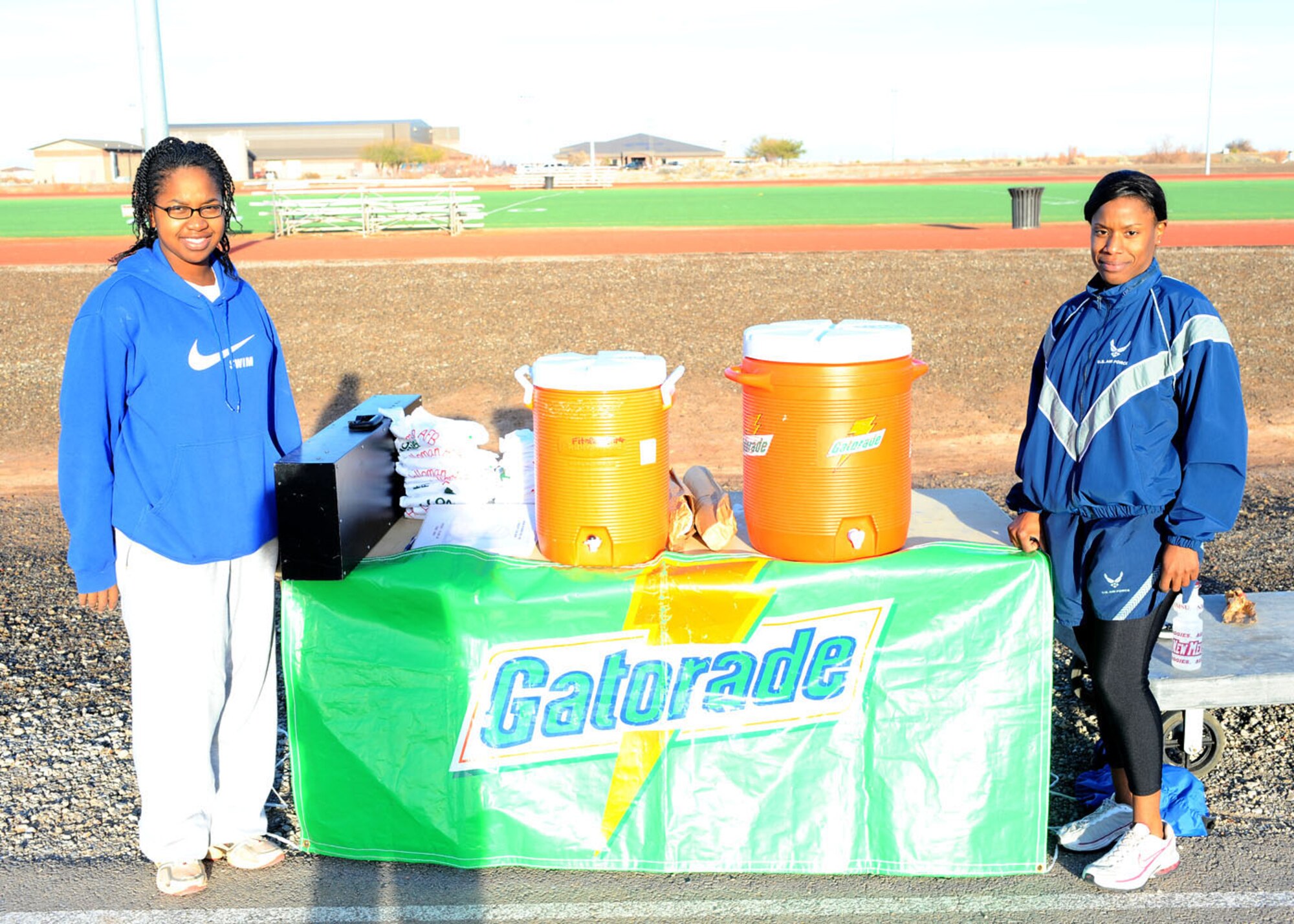 Airman 1st Class Connecticut Wilson and Airman 1st Class Charisse Balthazar from the 49th Force Support Squadron were the officials at the Holloman Air Force Base, N.M., Frosty 5K run at the Fitness and Sports Center track Dec. 19. The Fitness and Sports Center sponsors all the  monthly runs. (U.S Air Force photo/ Airman 1st Class DeAndre Curtiss)