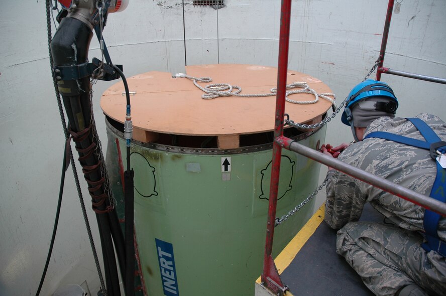 Airman 1st Class Stephen Sartini, 341st Maintenance Operations Squadron Team Training Section student, performs tasks required to "safe" an inert Minuteman III at the T-9 Trainer under the supervision of 341st Maintenance Operations Squadron Team Training Section instructors Dec. 16. Airmen must graduate team training before they perform their job in the missile complex. (U.S. Air Force photo/Senior Airman Dillon White)