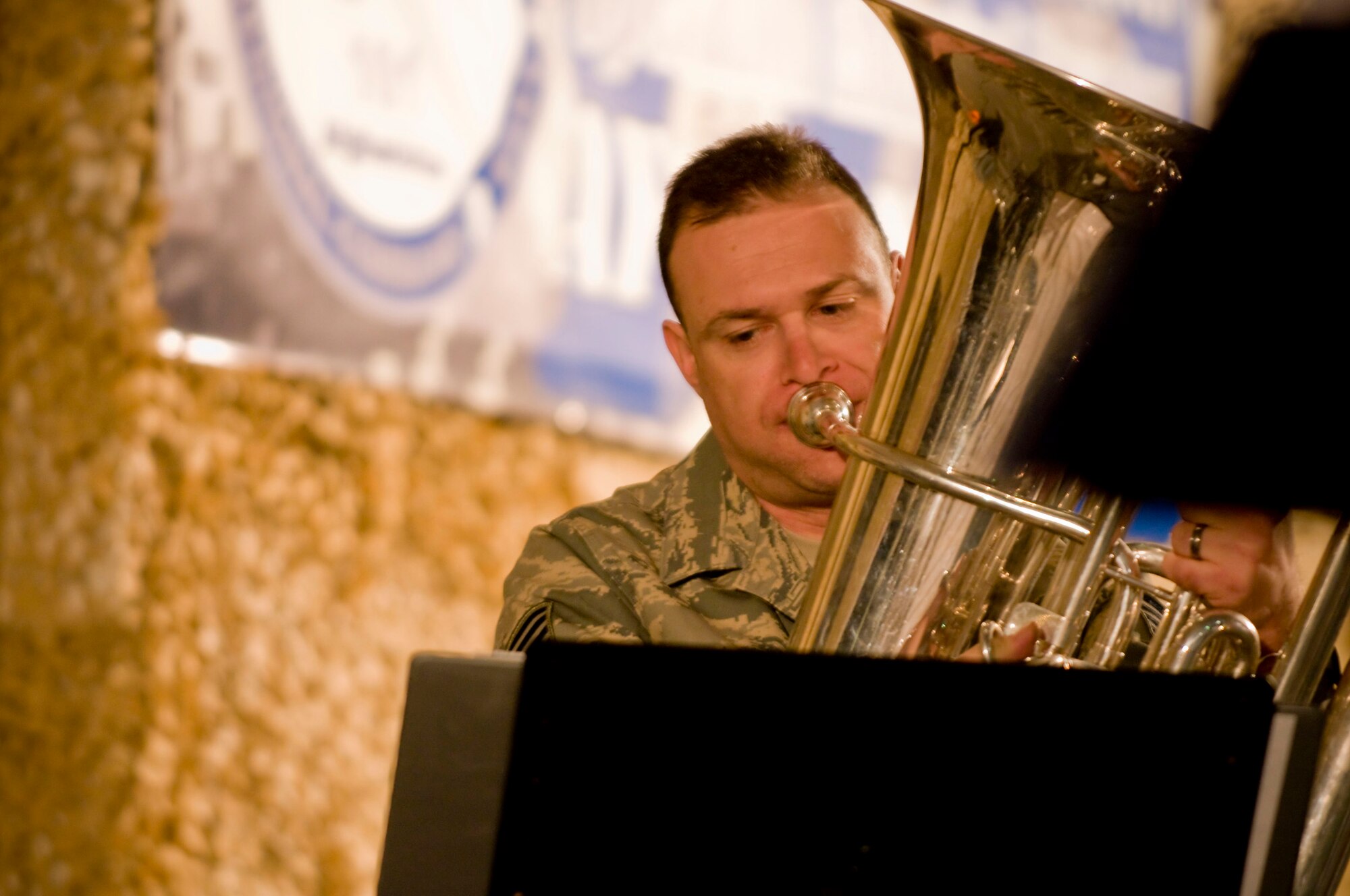 Tech. Sgt. Michael Andrew, tuba player for Air Forces Central band "Mojave," plays during the band's feature performance at Bagram Air Field, Afghanistan, Dec. 27. Mojave was brought together in such a way that they could break off for a brass quartet -- perfect for Christmas carols. However, during popular music, Sergeant Andrew played the part of the bass guitar. (U.S. Air Force photo by Staff Sgt. Samuel Morse)(Released)