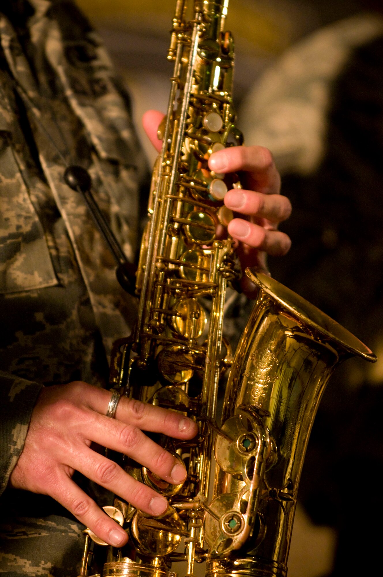 Staff Sgt. Miles Hudlow, saxophone player for Air Forces Central band "Mojave" plays alto saxophone during the band's feature performance at Bagram Air Field, Afghanistan, Dec. 27. The addition of a saxophone player allowed the band to balance-out its brass section during pop music, creating an overall sound that made Mojave perfect for music by artists such as the Beatles. Sergeant Hudlow is from Raleigh, N.C. (U.S. Air Force photo by Staff Sgt. Samuel Morse)(Released)