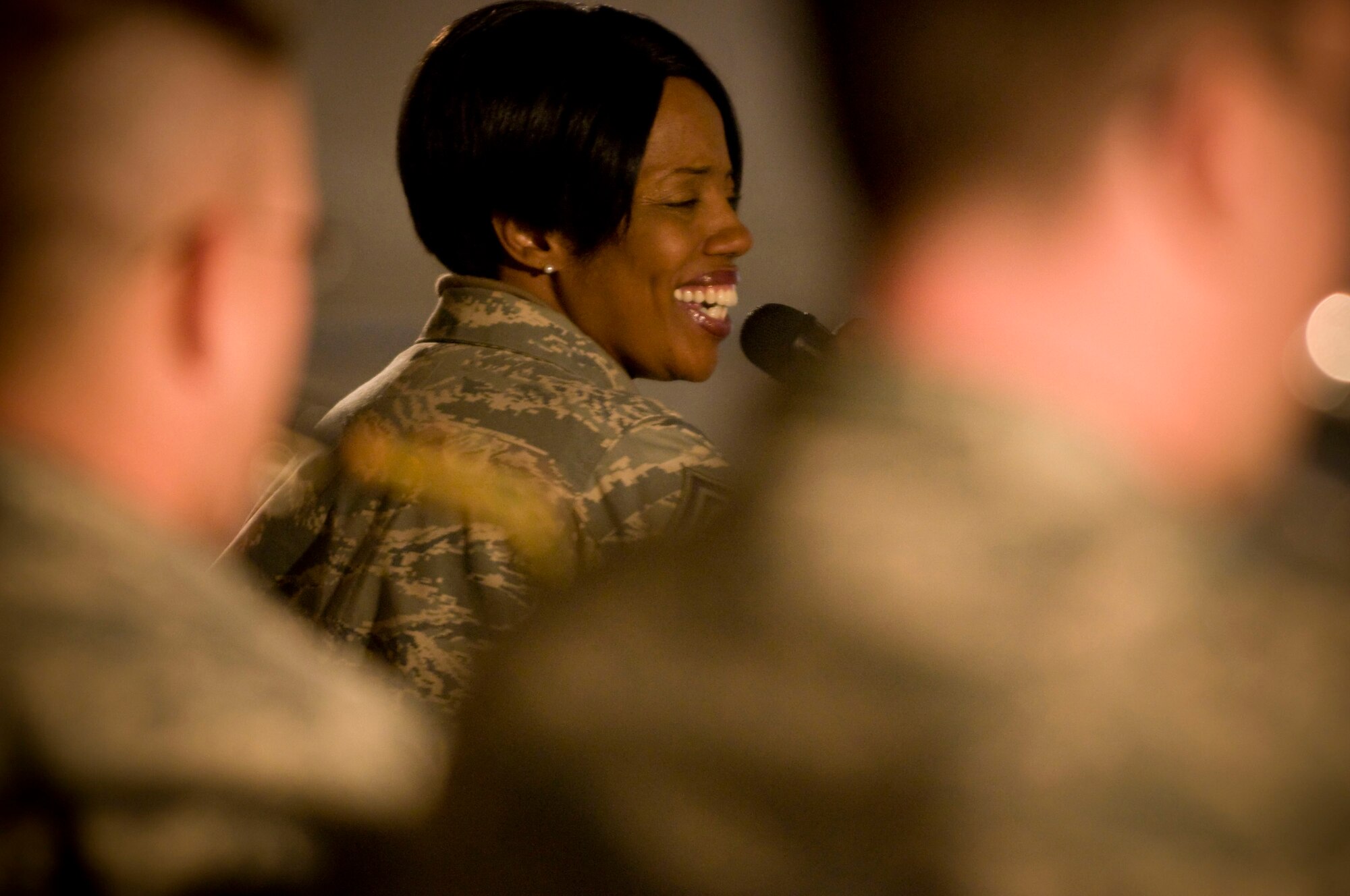 Senior Master Sgt. Debra Jamison, lead vocalist for Air Forces Central band "Mojave" sings during the band's feature performance at Bagram Air Field, Afghanistan, Dec. 27. The band played a diverse set of music covering a broad spectrum of popular music from the past half-century. (U.S. Air Force photo by Staff Sgt. Samuel Morse)(Released)