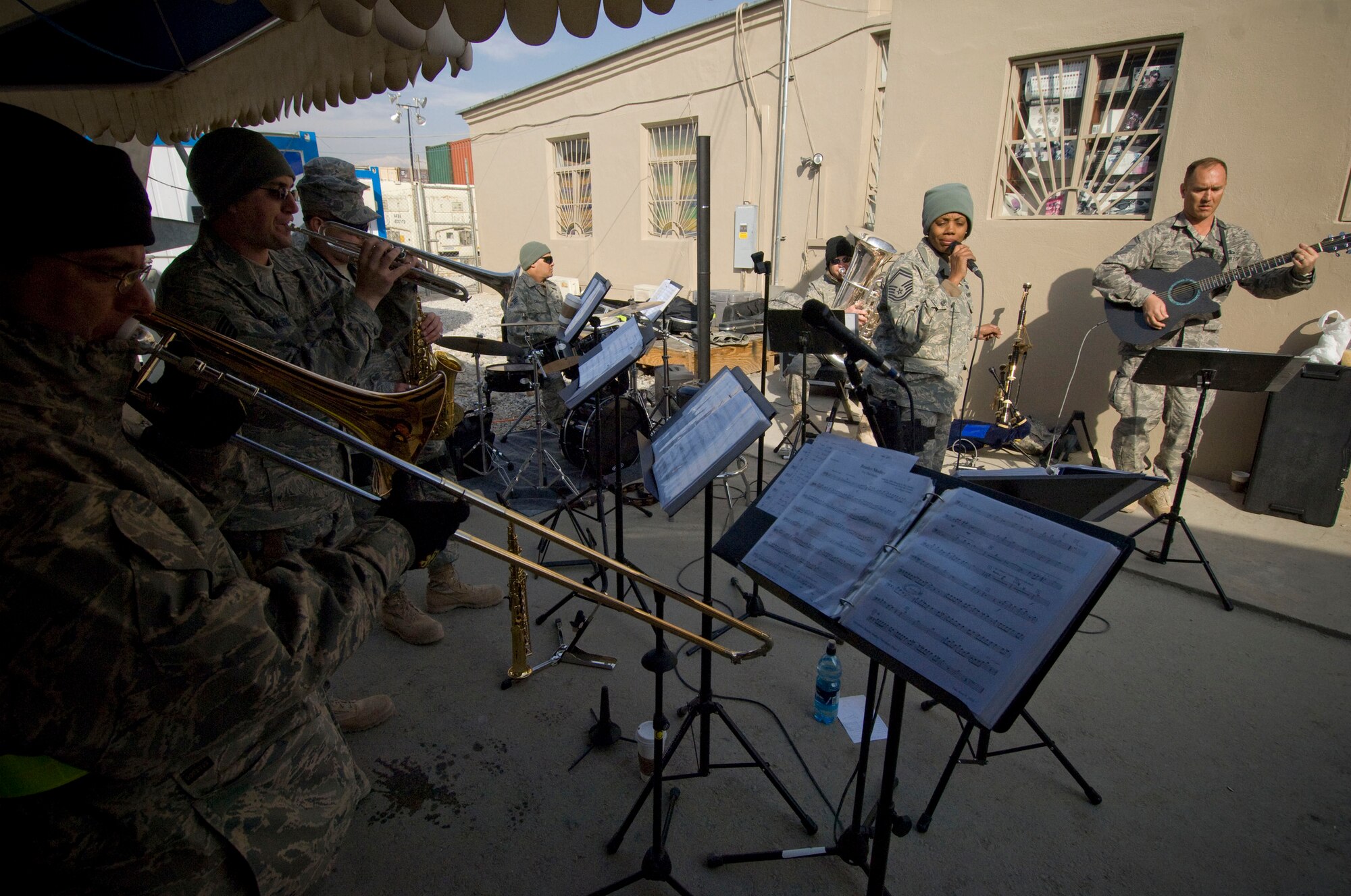 Air Forces Central band "Mojave" plays at the PX complex at Bagram Air Field, Afghanistan, Dec. 27. Deployed from Robins Air Force Base, Ga., the band has been traveling more than 6,000 miles throughout Southwest Asia to perform for the troops and build international relationships through the power of music. The somewhat informal show at the PX complex served as a warm-up and demo for their feature performance later that night. (U.S. Air Force photo by Staff Sgt. Samuel Morse)(Released)