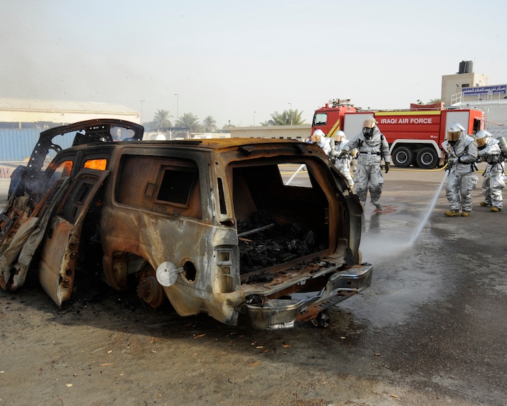 BAGHDAD, Iraq -- Master Sgt. James Brody, center, assistant firefighter instructor, observes Iraqi firefighters as they extinguish a fire during a training exercise in Baghdad, Iraq on Dec. 24. Brody, a Syracuse, N.Y. native, is deployed to the 447th Expeditionary Civil Engineer Squadron, Sather Air Base, Iraq where he is the training chief. (U.S. Air Force photo/Staff Sgt. Paul Villanueva II)
