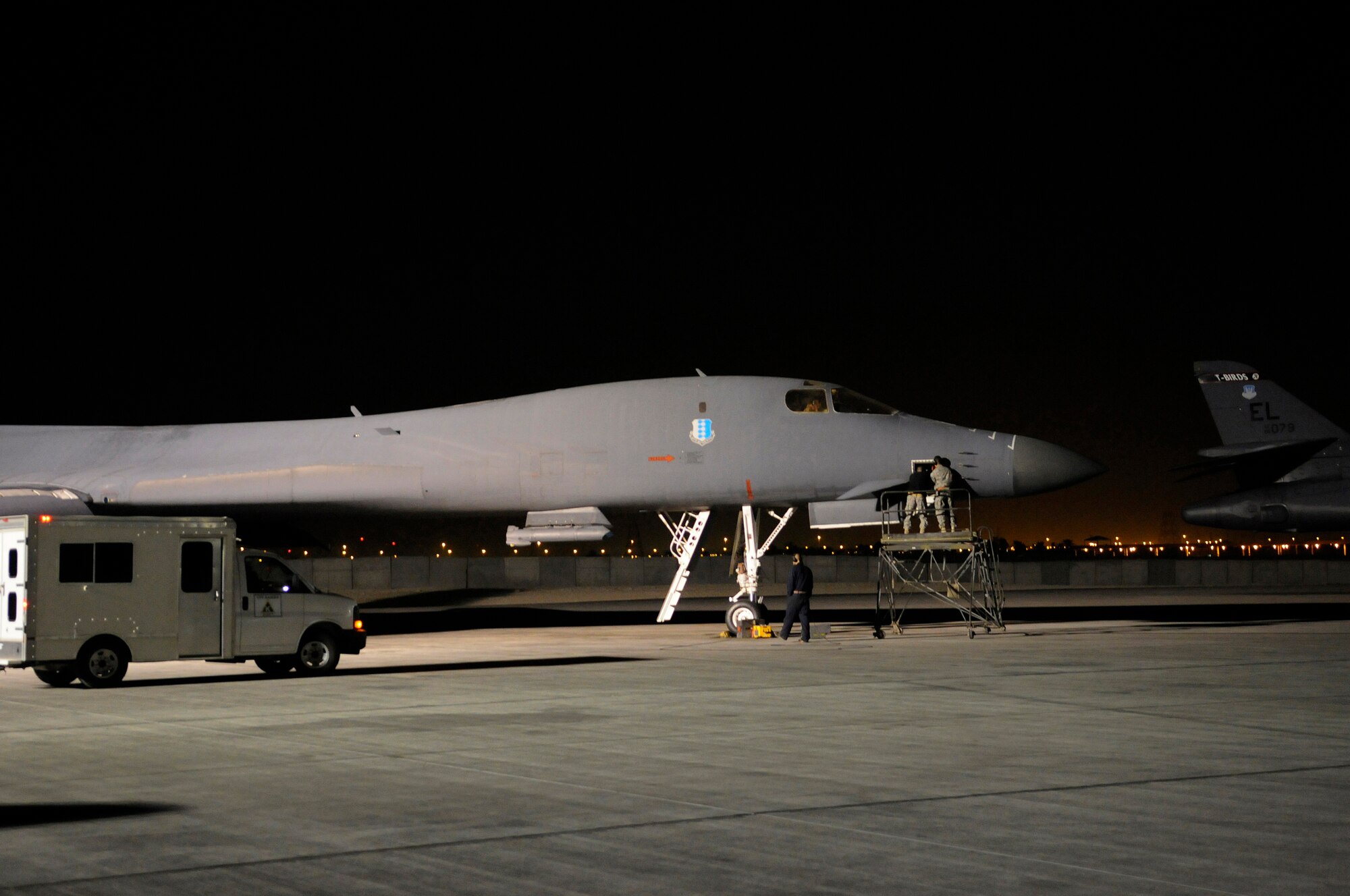 Senior Airman Adam Hall and Senior Airman Peter Yurgin, aircraft maintenance journeymen assigned to the 379th Expeditionary Aircraft Maintenance Squadron, replace a part on a B-1B Lancer as it waits take off, Dec. 28, at an undisclosed air base in Southwest Asia.  The B-1B carries the largest payload in the Air Force inventory and can rapidly deliver massive quantities of precision and non-precision weapons against any adversary in the Central Command area of responsibility.  Airman Hall, from Nashville, Tenn., and Airman Yurgin, from Atlantic City, N.J., are both deployed from Ellsworth Air Force Base, S.D. in support of Operations Iraqi and Enduring Freedom and Joint Task Force-Horn of Africa.  (U.S. Air Force photo by Tech. Sgt. Michael Boquette/Released)