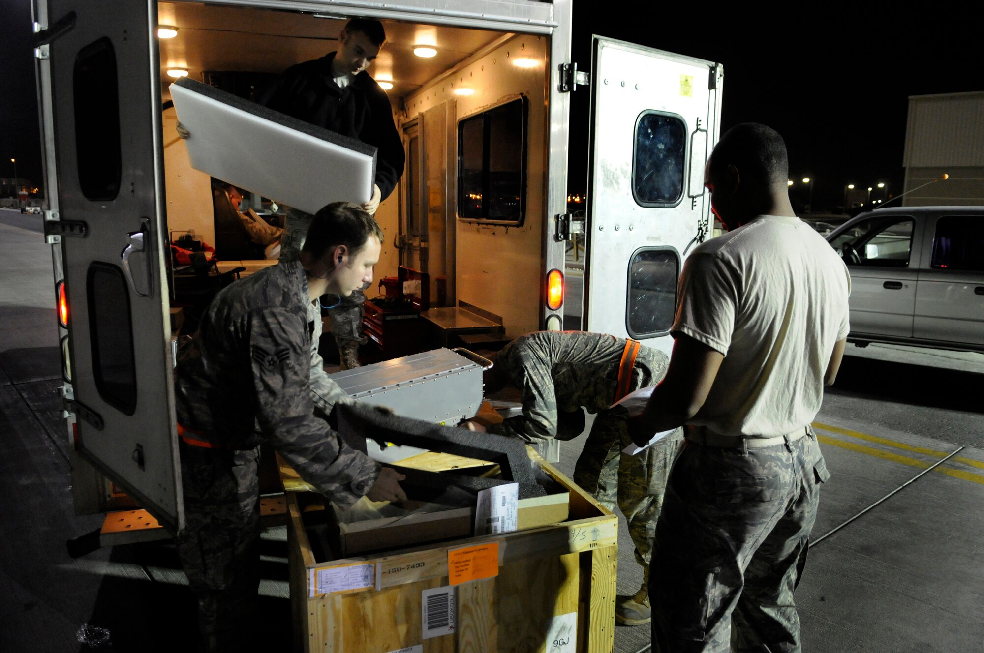 Staff Sergeant Daniel Harrington, a supply journeyman assigned to the 379th Expeditionary Logistics Readiness Squadron, awaits a signature on a delivery receipt while Senior Airman Adam Hall, Senior Airman Peter Yurgin and Airman 1st Class Cody Pratt, aircraft maintenance journeymen assigned to the 379th Expeditionary Aircraft Maintenance Squadron, check over a part and prepare it for a B-1B Lancer waiting to take off, Dec. 28, at an undisclosed air base in Southwest Asia.  The B-1B carries the largest payload in the Air Force inventory and can rapidly deliver massive quantities of precision and non-precision weapons against any adversary in the Central Command area of responsibility.  Sergeant Harrington is a native of Atlanta, Ga., and deployed from MacDill Air Force Base, Fla.  Airman Hall, from Nashville, Tenn., Airman Yurgin, fromAtlantic City, N.J., and Airman Pratt,from Parkersburg, W.Va., are all deployed from Ellsworth Air Force Base, S.D. in support of Operations Iraqi and Enduring Freedom and Joint Task Force-Horn of Africa.  (U.S. Air Force photo by Tech. Sgt. Michael Boquette/Released)