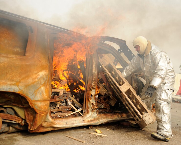 BAGHDAD, Iraq -- Master Sgt. James Brody, assistant firefighter instructor, creates a simulated car fire for a live burn exercise in Baghdad, Iraq on Dec. 24. Brody, a Syracuse, N.Y. native, is deployed from the 174th Fighter Wing, Syracuse Air National Guard, N.Y. (U.S. Air Force photo/Staff Sgt. Paul Villanueva II)