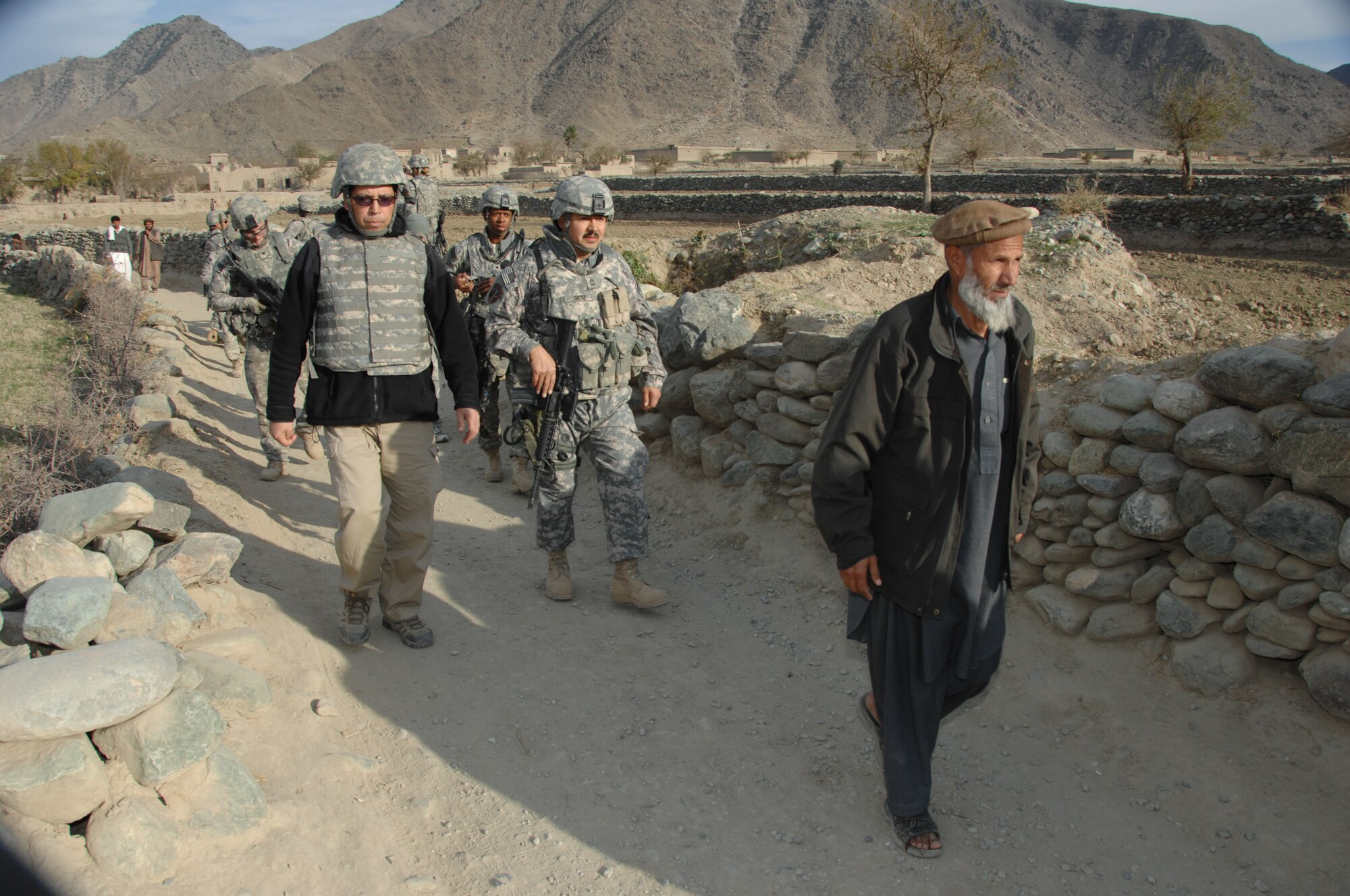 An Afghan village elder leads members of the Konar Provincial Reconstruction Team to take a look at a well in Manawara District, Konar province, Afghanistan, Dec. 14. (U.S. army photo by Spc. Russell Gilchrest)(Released)