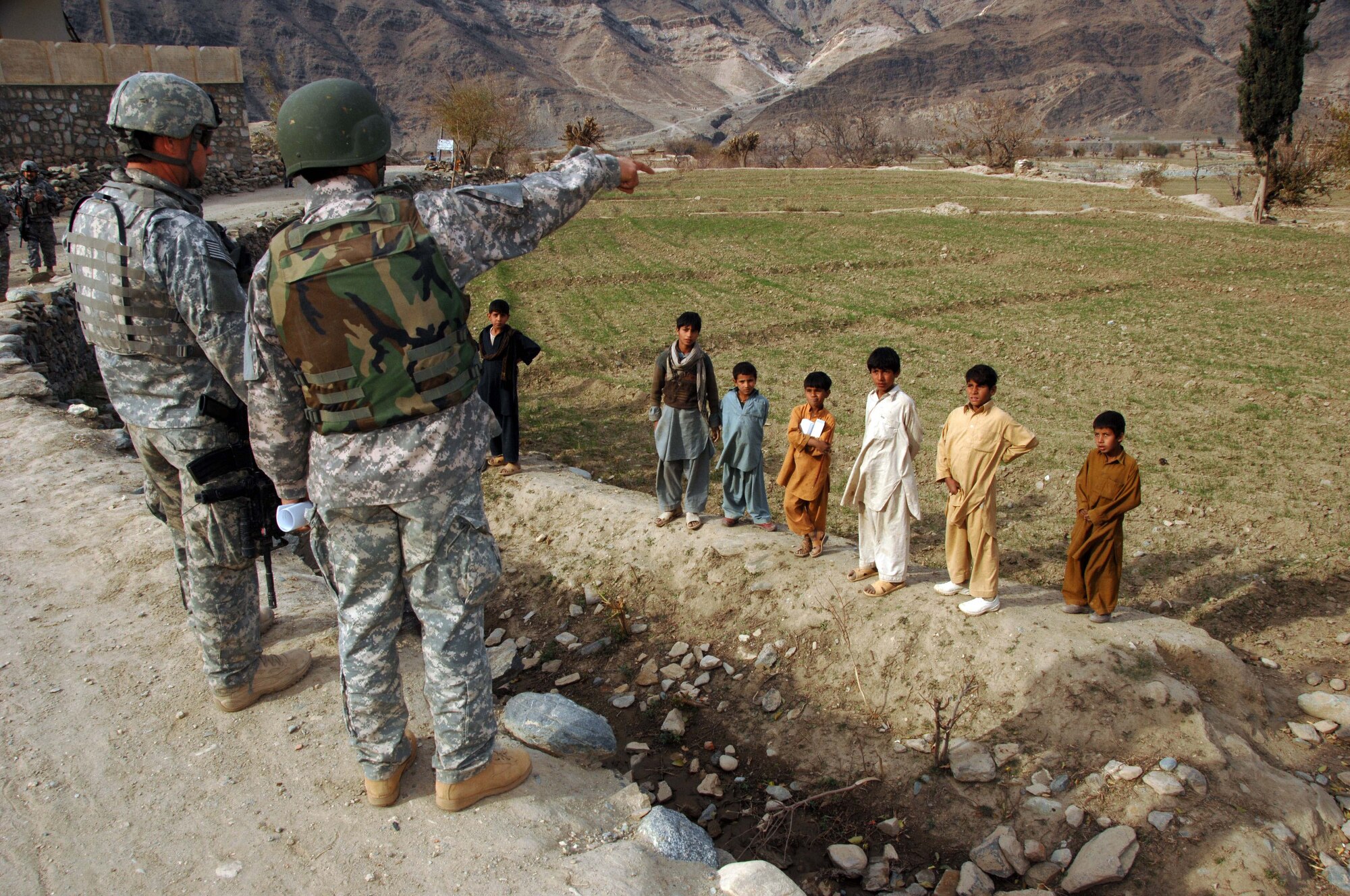 Members of the Konar Provincial Reconstruction Team speak with Afghan children during a mission in Manawara District, Konar province, Afghanistan, Dec. 14. (U.S. army photo by Spc. Russell Gilchrest)(Released)