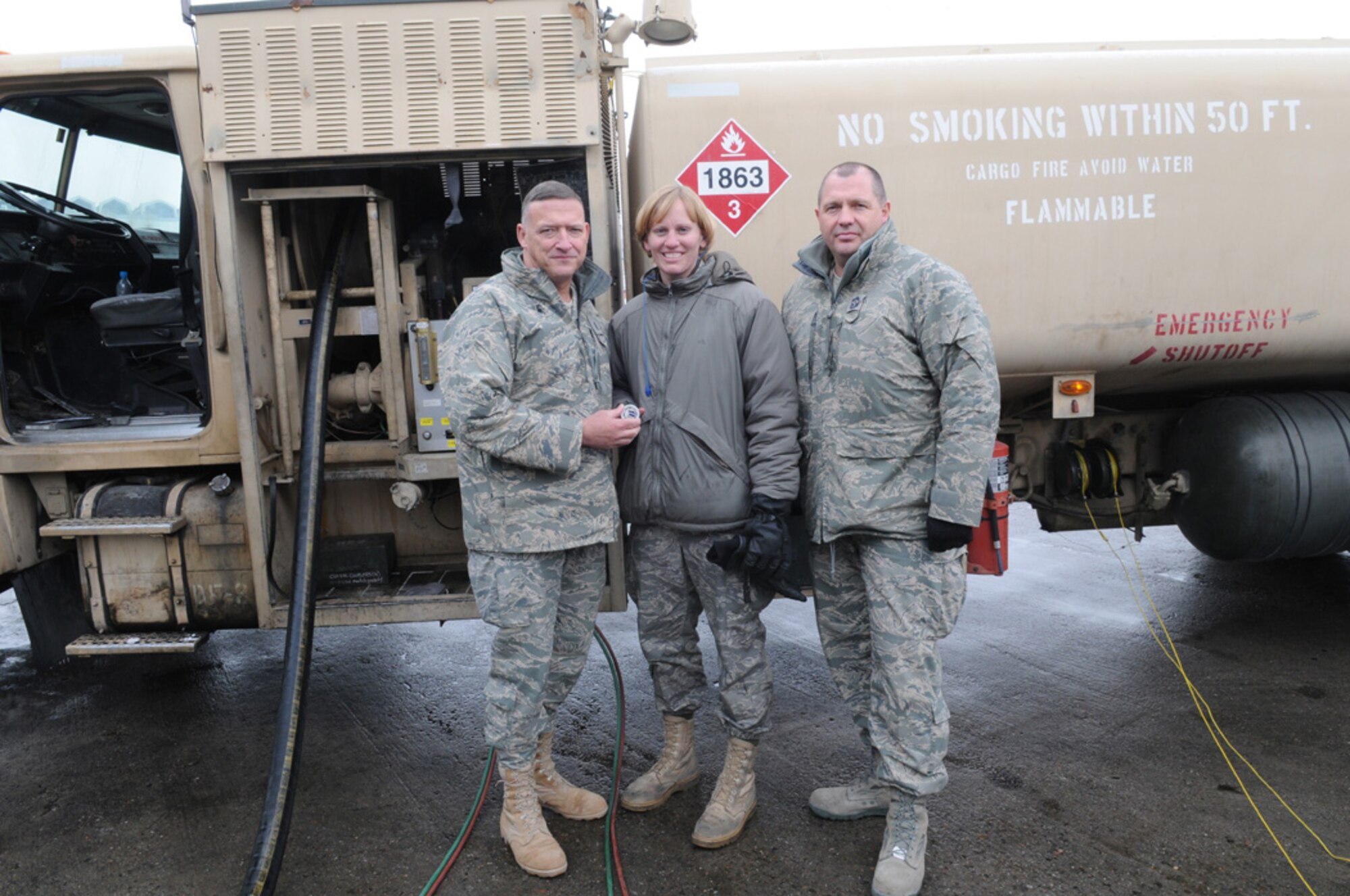 MANAS AIR BASE, KYRGYZSTAN -- Senior Airman Victoria Drefs, a fuels specialist with the 376th Air Expeditionary Wing here, recieves a commander's coin from Lt. Gen. Gary North, Air Forces Central Commander, for reaching the 2 million gallon mark for fuel delivered during her deployment.  The Armour S.D. native, deployed to Manas for four months from Aviano Air Base, Italy, is the first and likely only Airman to reach 2 million gallons this rotation. (Air Force photo / Senior Airman Ruth Holcomb)