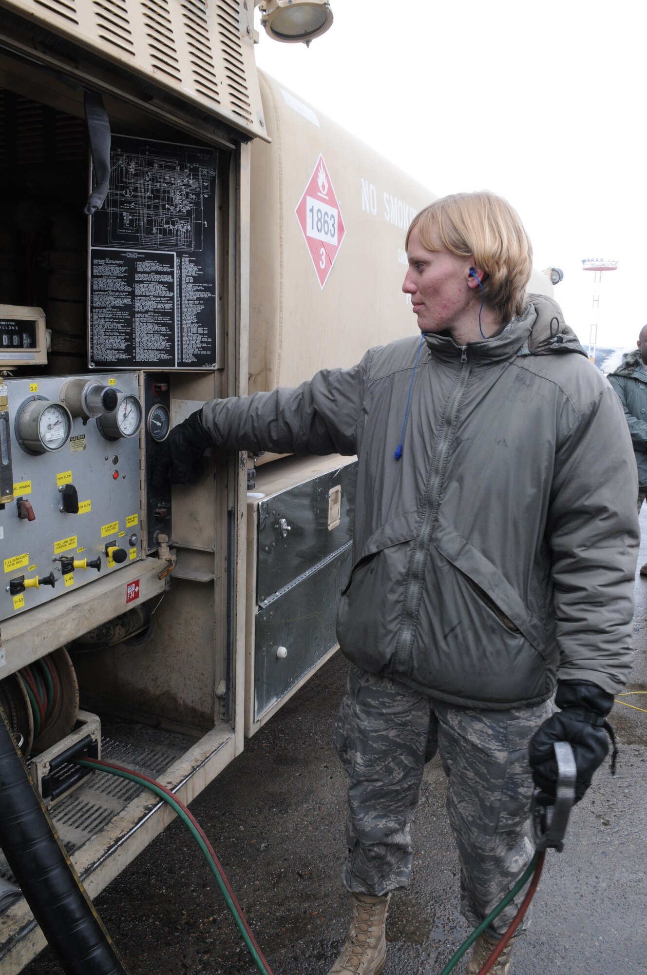 MANAS AIR BASE, KYRGYZSTAN -- Senior Airman Victoria Drefs, a fuels specialist with the 376th Air Expeditionary Wing here, prepares to pump fuel from her R-11 fuel trunk into a KC-135 Stratotanker to surpass the 2 million gallon mark for fuel delivered during her deployment.  The Armour S.D. native, deployed to Manas for four months from Aviano Air Base, Italy, is the first and likely only Airman to reach 2 million gallons this rotation. (Air Force photo / Senior Airman Ruth Holcomb)