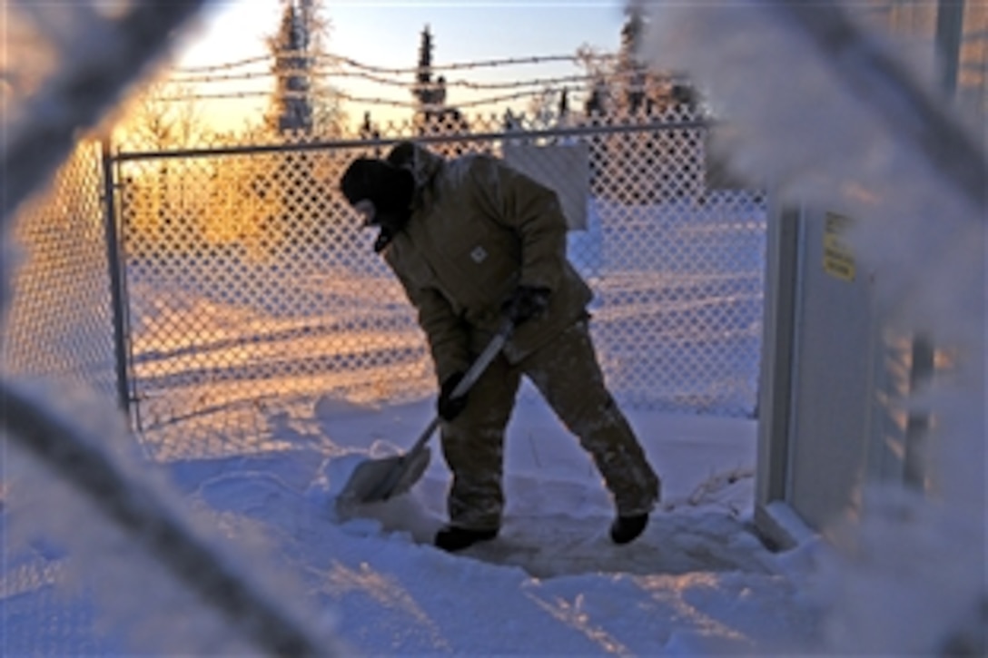 U.S. Air Force Maj. Anthony Deluca clears a pathway at an Alaska Long Period Array site, at a remote operating facility on the Pacific Alaska Range Complex, Eielson Air Force Base, Alaska, Dec. 16, 2008. Deluca is the commander, Detachment 460. The detachment monitors underground nuclear seismic activity and atmospheric nuclear radiation and collects ground samples for analysis. 