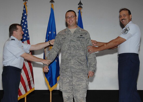 ANDERSEN AIR FORCE BASE, Guam - Brig. Gen. Philip Ruhlman, 36th Wing, commander and Chief Master Sergeant Bud Andree, 36th Wing, Command Chief Master Sergeant, welcome Master Sgt. Timothy Galunas into the ranks of a senior noncommissioned officer during a step promotion Dec. 30. Sergeant Galunas is the communications flight chief here for the 36th Mobility Response Squadron. (U.S. Air Force photo by Senior Airman Sonya Croston)