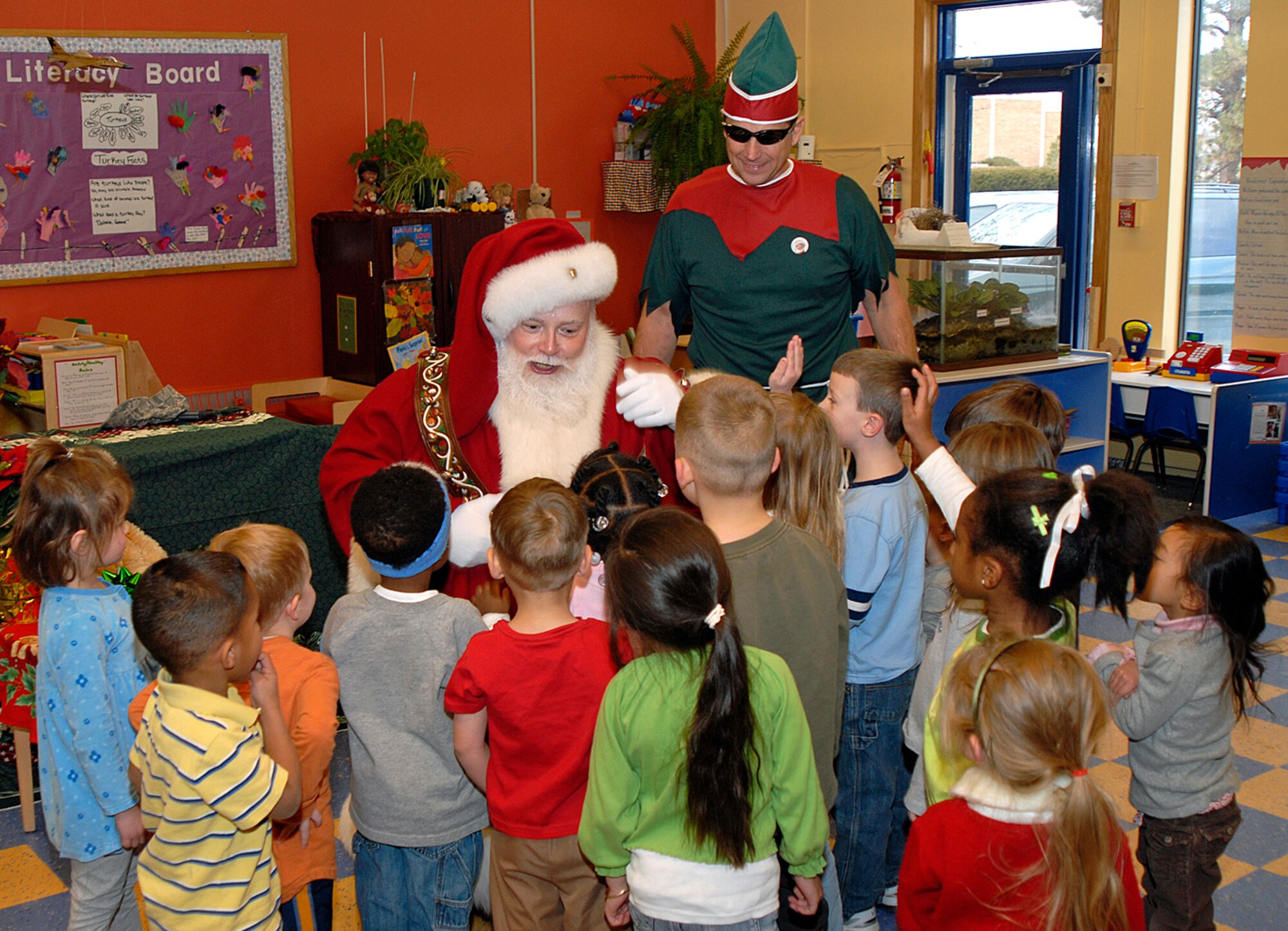 Santa interacts with the children at the Peterson Air Force Base Child Development Center.  (Photo by Craig Denton)

