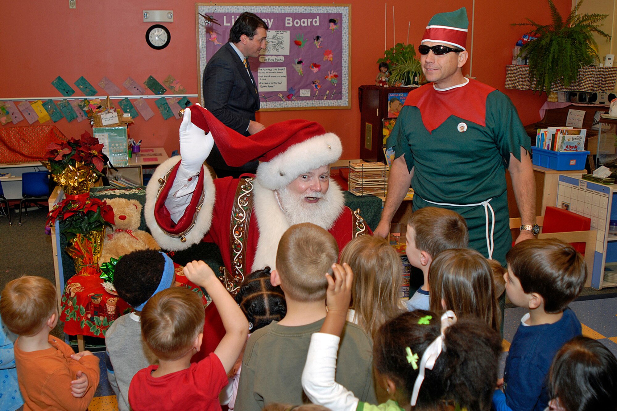 Santa interacts with the children at the Peterson Air Force Base Child Development Center.  (Photo by Craig Denton)

