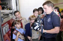 Homestead ARB fire fighter, Mr. Jeffery Curl, 482nd Civil Engineering Squadron, demonstrates how a thermal imagining camera is used to kids and chaperones from Boy and Girl Scout Troop 599 on Dec. 30.  The Miami Scouts were treated to a tour of the base fire department and air traffic control tower; watched four F-16 fighter jets take-off; and then ate lunch at the Falcons Nest Club.  Homestead ARB offers two tours a month. Groups interested in touring the base should contact the 482nd Fighter Wing Public Affairs Office at least 60 days in advance. The PA office can be reached at (305) 224-7330. (U.S. Air Force photo/Tim Norton)