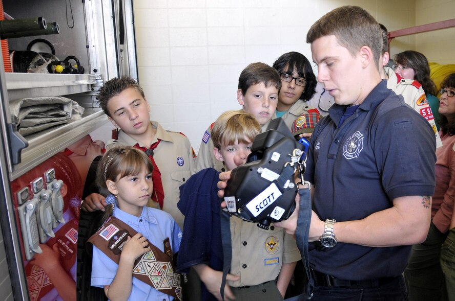 Homestead ARB fire fighter, Mr. Jeffery Curl, 482nd Civil Engineering Squadron, demonstrates how a thermal imagining camera is used to kids and chaperones from Boy and Girl Scout Troop 599 on Dec. 30.  The Miami Scouts were treated to a tour of the base fire department and air traffic control tower; watched four F-16 fighter jets take-off; and then ate lunch at the Falcons Nest Club.  Homestead ARB offers two tours a month. Groups interested in touring the base should contact the 482nd Fighter Wing Public Affairs Office at least 60 days in advance. The PA office can be reached at (305) 224-7330. (U.S. Air Force photo/Tim Norton)
