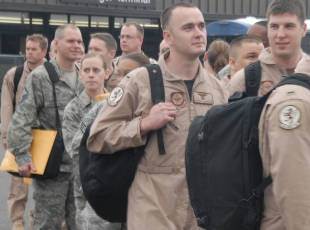 Airmen from the 16th Airlift Squadron and the 437th Operations Support Squadron line up outside the 437th Aerial Port Squadron passenger terminal on the Charleston AFB flightline Dec. 29. More than 140 Airmen are deploying to a forward deployed location in Southewest Asia as part of Operations Enduring and Iraqi Freedom. (U.S. Air Force photo/Airman Ian Hoachlander)