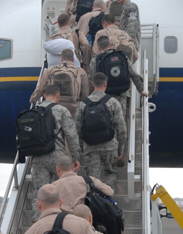 Airmen from the 16th Airlift Squadron and the 437th Operations Support Squadron make their way from the Charleston AFB's passenger terminal to the aircraft that will take them to Southwest Asia for a four-month deployment Dec. 29. The 16 AS will assume control of the 816th Expeditionary Airlift Squadron from the 15th Airlift Squadron based out of Charleston AFB. (U.S. Air Force photo/Airman Ian Hoachlander)