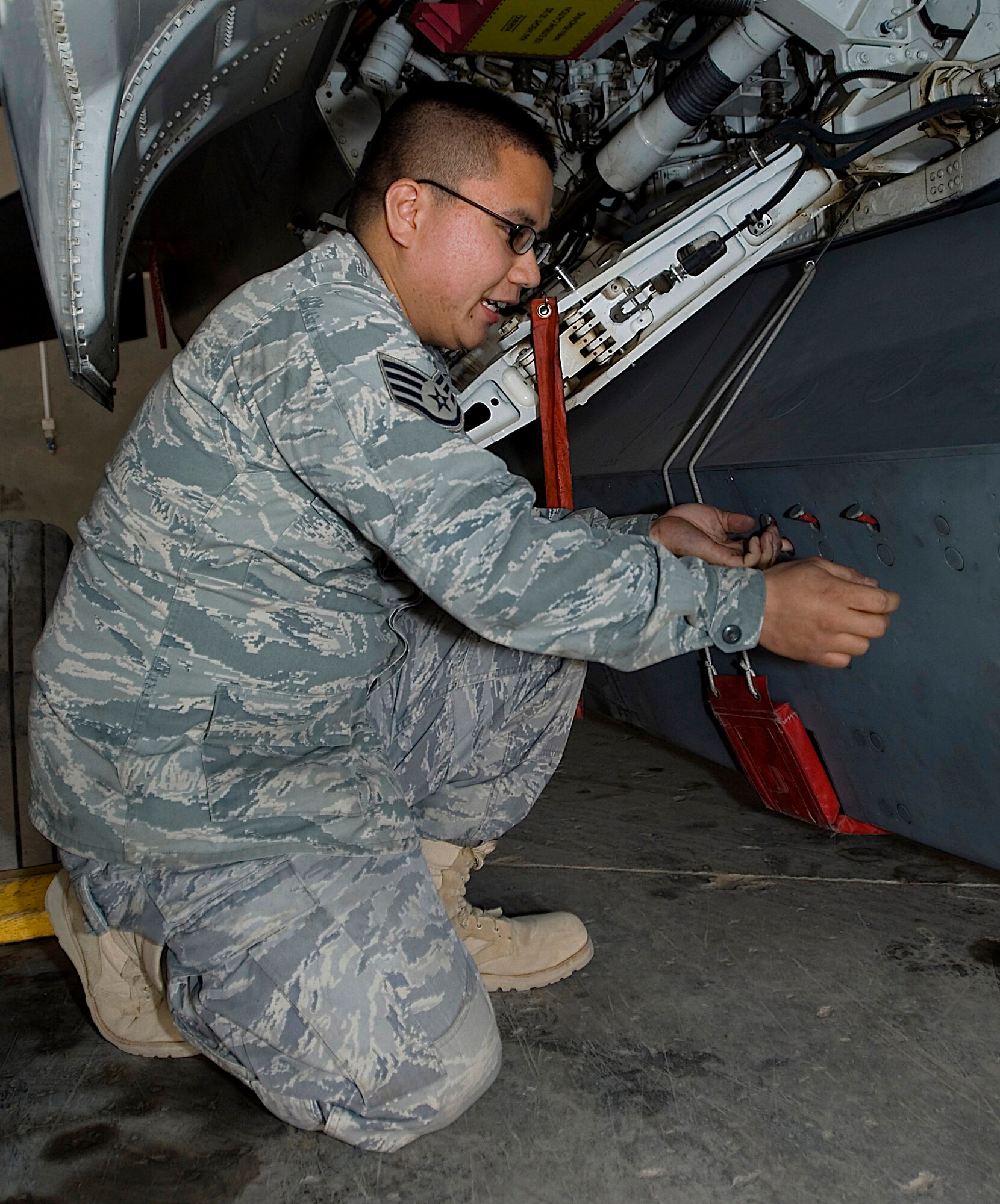 Staff Sgt. Christopher Tobias opens a panel Dec. 21 on a Theater Airborne Reconnaissance System pod mounted on an F-16 Fighting Falcon at Joint Base Balad, Iraq. Ground commanders use TARS imagery to achieve their tactical objectives. Sergeant Tobias, one of four 332nd Expeditionary Aircraft Maintenance Squadron avionics maintainers responsible for the 332nd Expeditionary Fighter Squadron's TARS pods, is a native of Long Beach, Calif., and is deployed from Luke Air Force Base, Ariz. (U.S. Air Force Photo/Tech. Sgt. Erik Gudmundson)