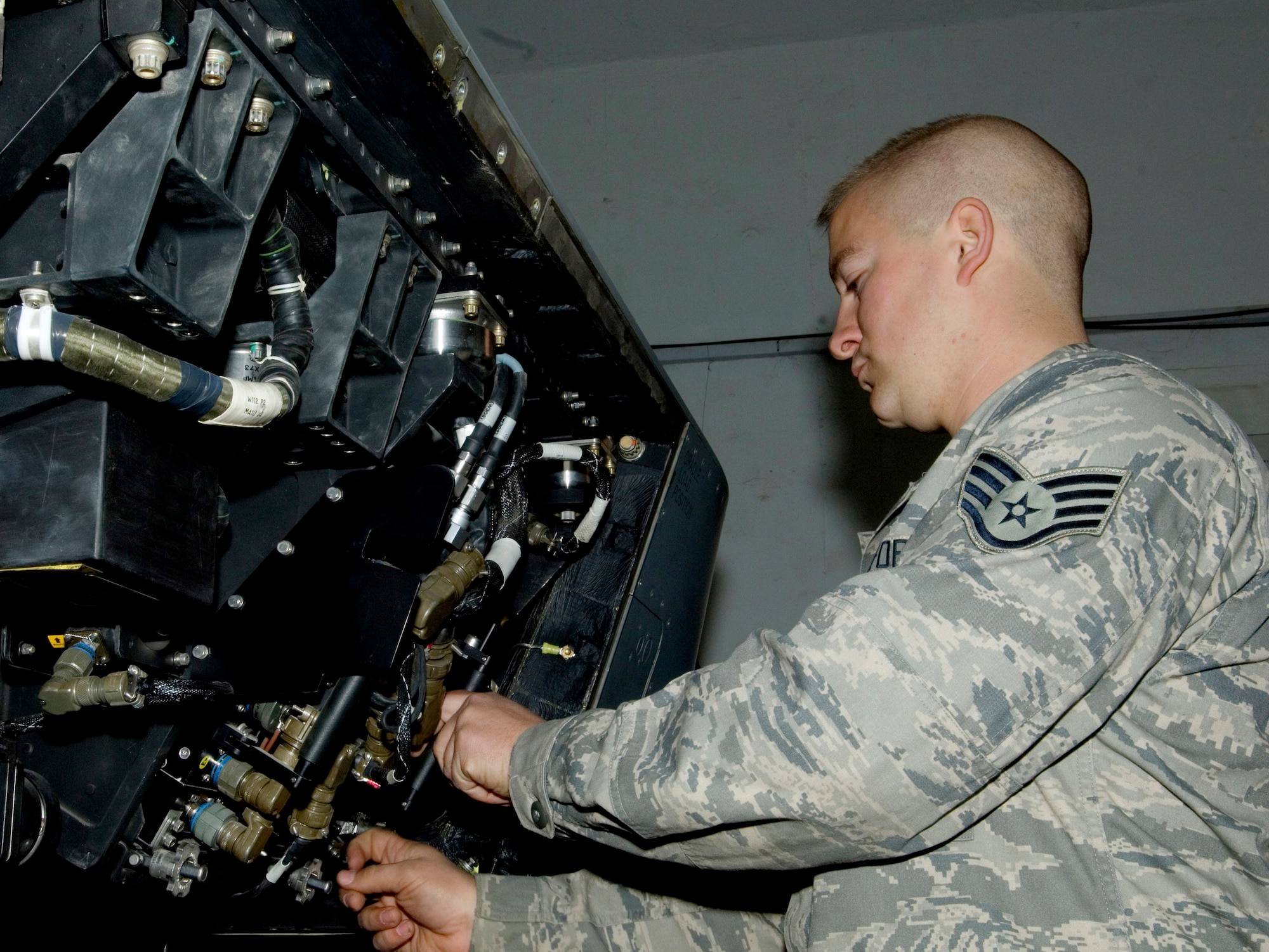 Staff Sgt. George Suonvieri adjusts the flash drive used for storage aboard a Theater Airborne Reconnaissance System pod mounted on an F-16 Fighting Falcon Dec. 21 at Joint Base Balad, Iraq. Ground commanders use TARS imagery to achieve their tactical objectives. Sergeant Suonvieri is one of four 332nd Expeditionary Aircraft Maintenance Squadron avionics maintainers responsible for the 332nd Expeditionary Fighter Squadron's TARS pods. Sergeant Suonvieri, a native of Duluth, Minn., is deployed from the Minnesota Air National Guard's 148th Fighter Wing. (U.S. Air Force photo/Tech. Sgt. Erik Gudmundson)