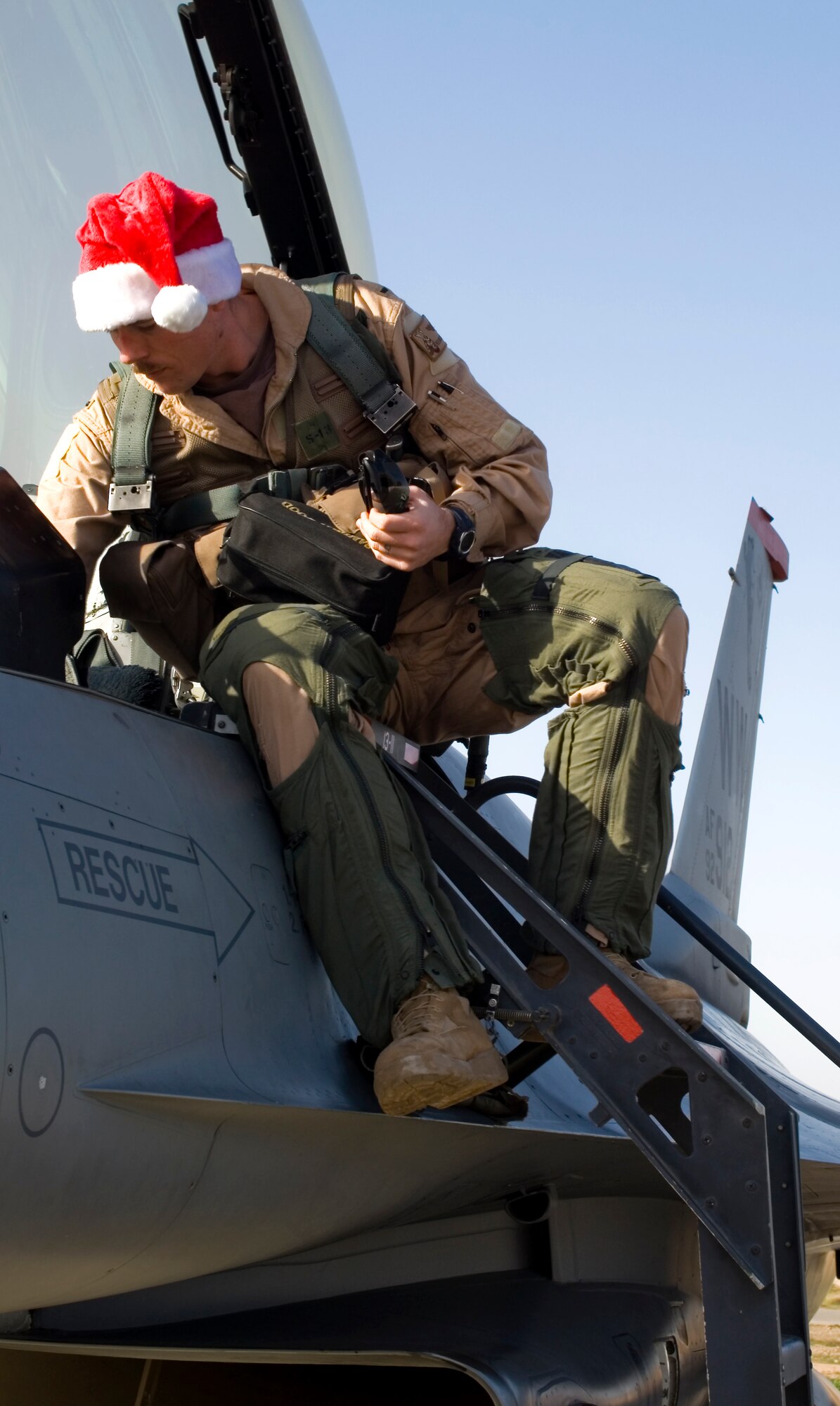 Capt. Kevin Danaher climbs out of the cockpit of his F-16 Fighting Falcon after being promoted in an airborne ceremony over Iraq Dec. 25. Lt. Col. Shane Riza, commander of the 14th Expeditionary Fighter Squadron at Joint Base Balad, Iraq, administered the oath of office to Danaher while in flight. Danaher, the 14th EFS standardization and evaluations liaison officer and a native of Crystal River, Fla., is deployed from Misawa Air Base, Japan. (U.S. Air Force photo/Tech. Sgt. Erik Gudmundson)