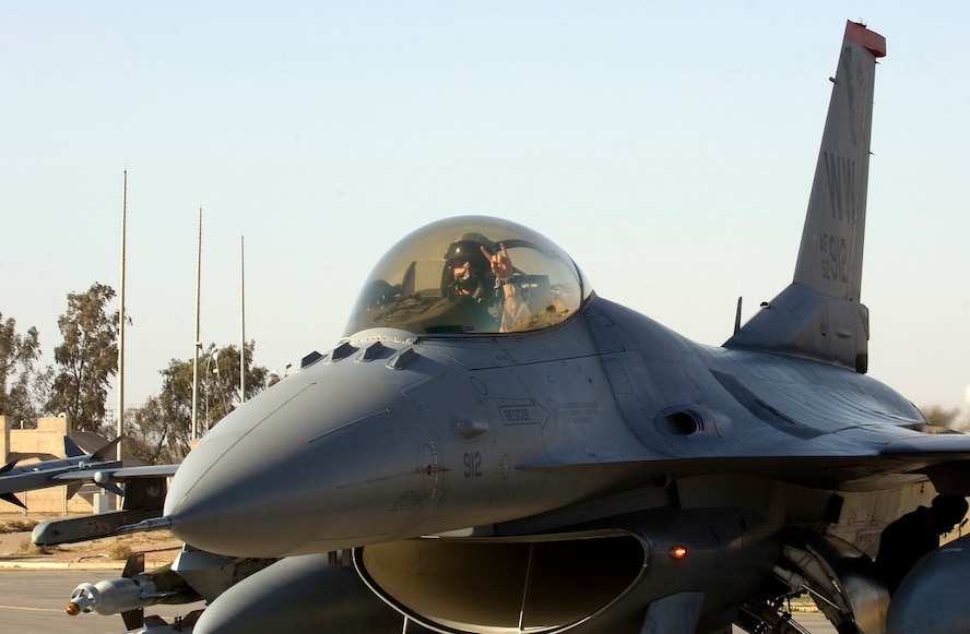 Capt. Kevin Danaher flashes a hand signal from the cockpit of his F-16 Fighting Falcon at Joint Base Balad, Iraq, after being promoted in an airborne ceremony Dec. 25. Danaher, the standardization and evaluations liaison for the 14th Expeditionary Fighter Squadron and a native of Crystal River, Fla., is deployed from Misawa Air Base, Japan. (U.S. Air Force photo/Tech. Sgt. Erik Gudmundson)
